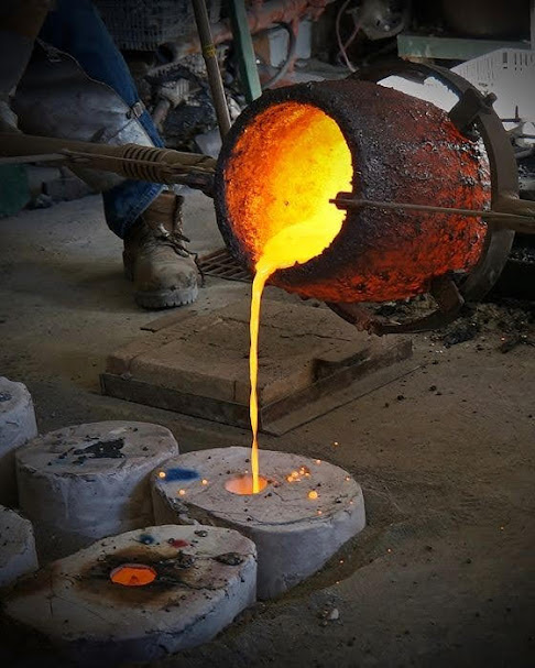 Molten metal pouring from crucible