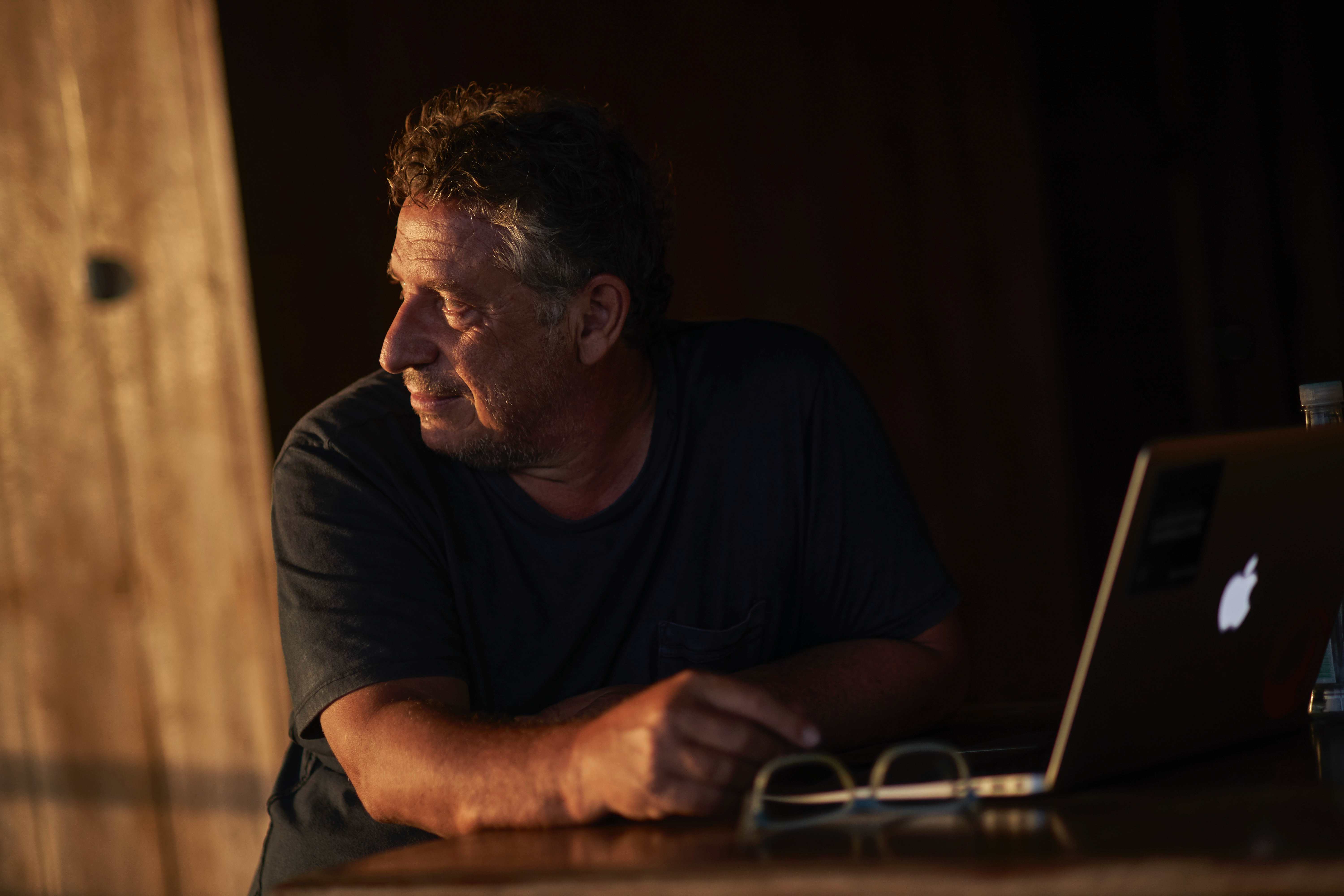 Francesc Badia i Dalmases working at a laptop in the field