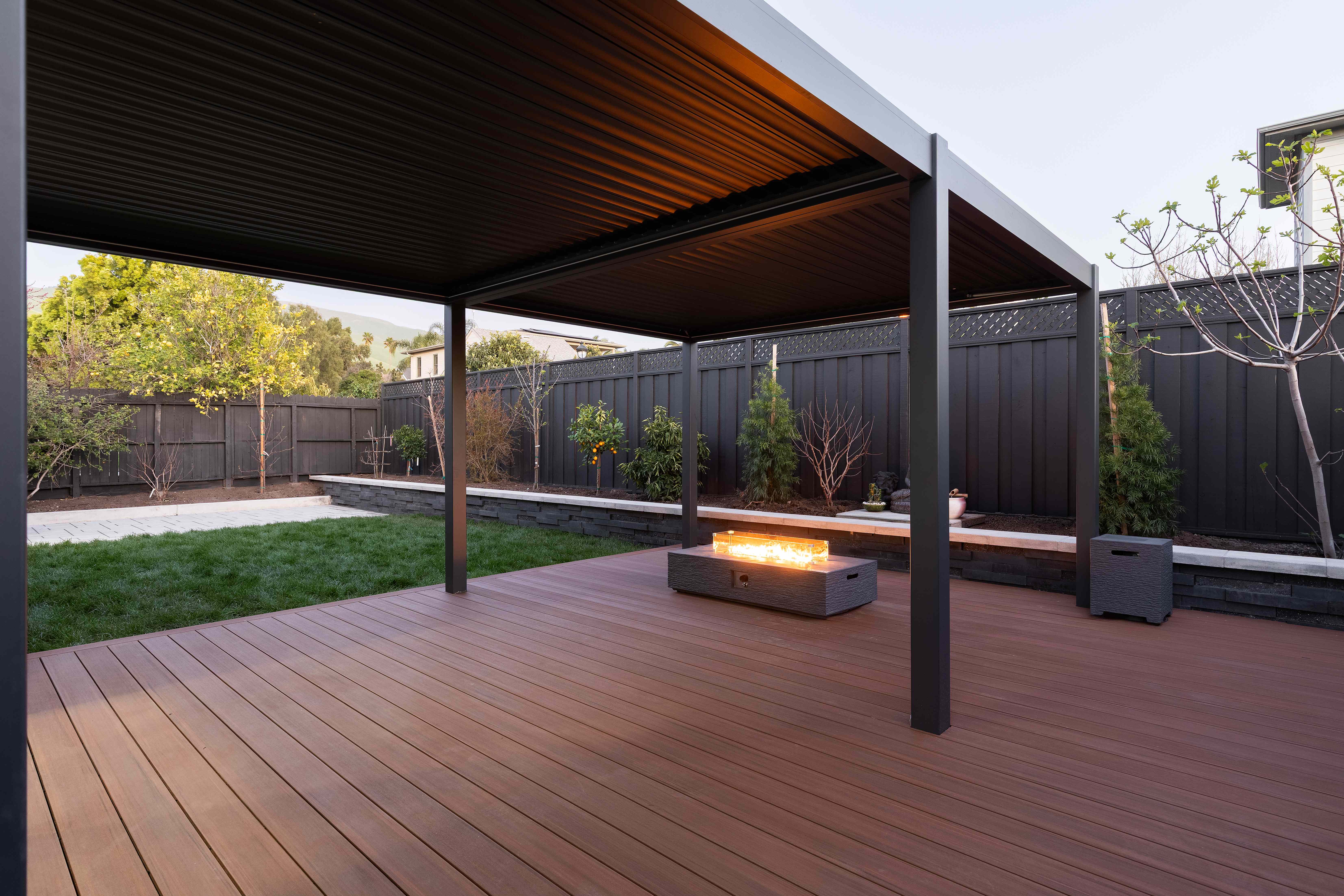 Completed backyard with pergola, deck, and fire pit