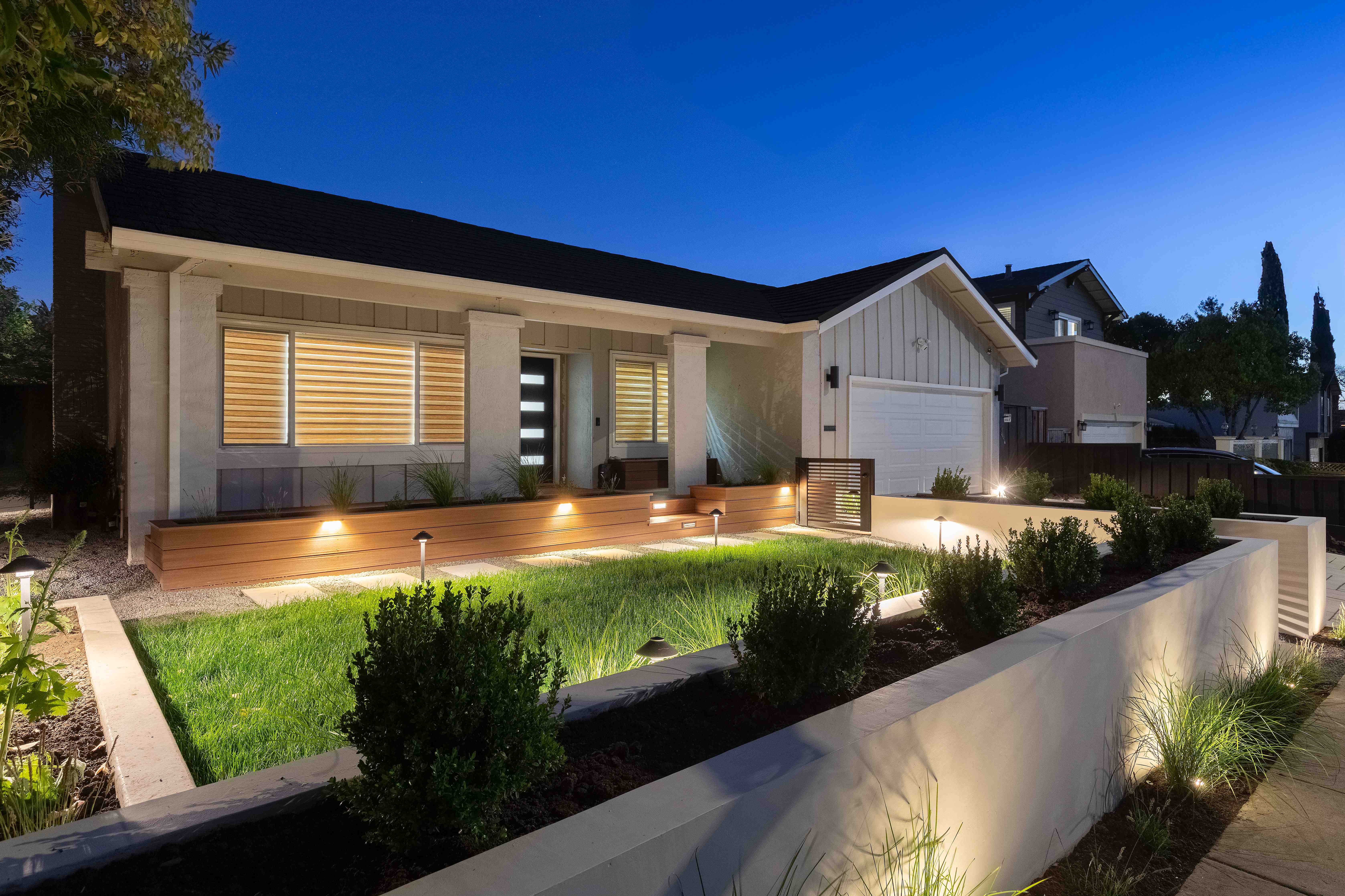 Front yard at twilight with landscape lighting