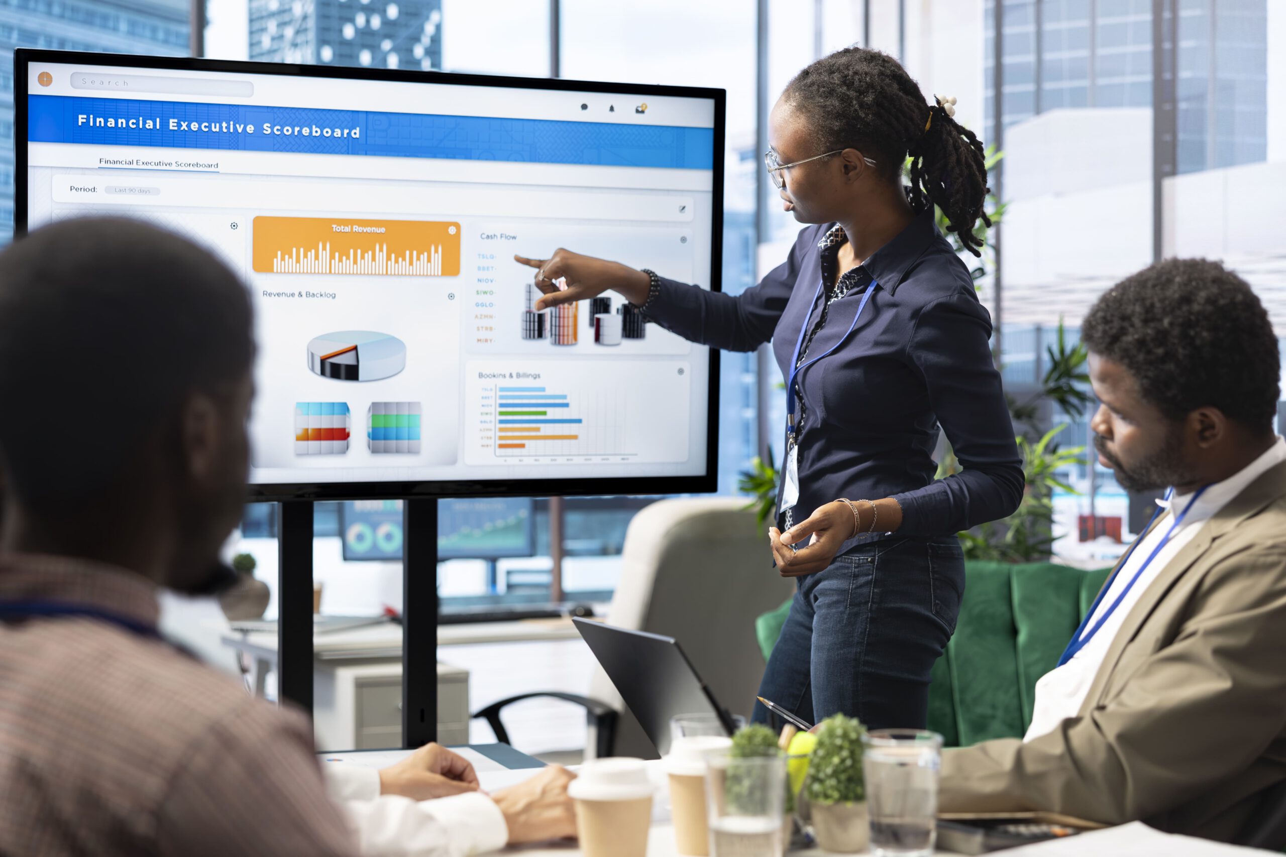 Business team analyzing data insights on large display