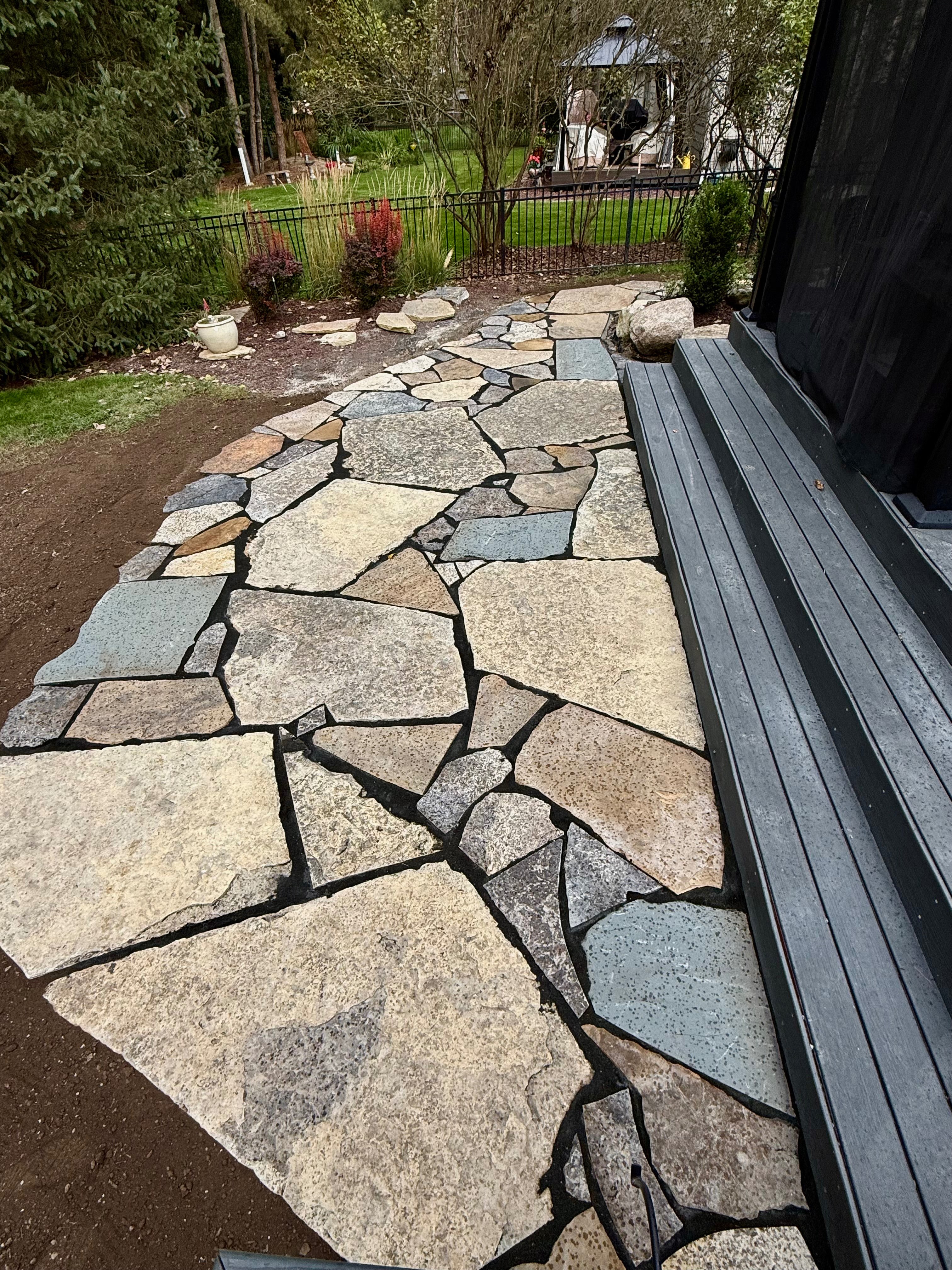 Natural flagstone walkway leading to a screened porch, installed by ARP in Mid-Michigan