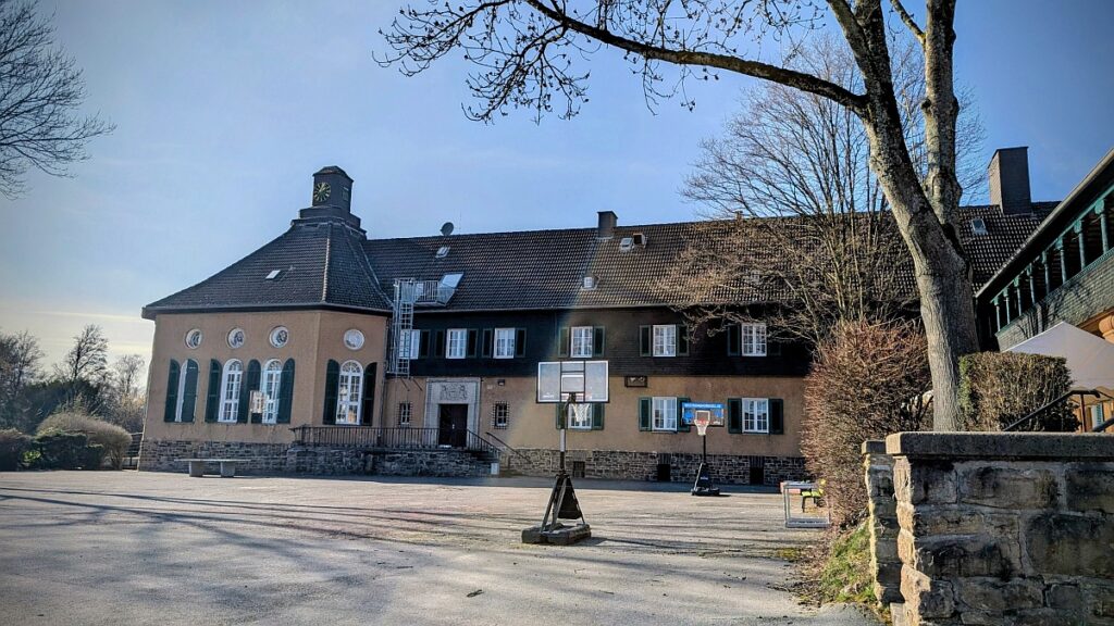 Hof der Funke Stiftung mit Basketballkorb und Uhrenturm