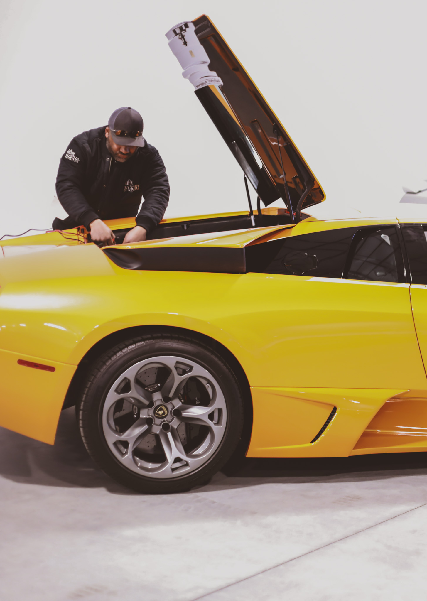 Lamborghini Murcielago yellow with hood open, GoTime Motorsports team member working on it