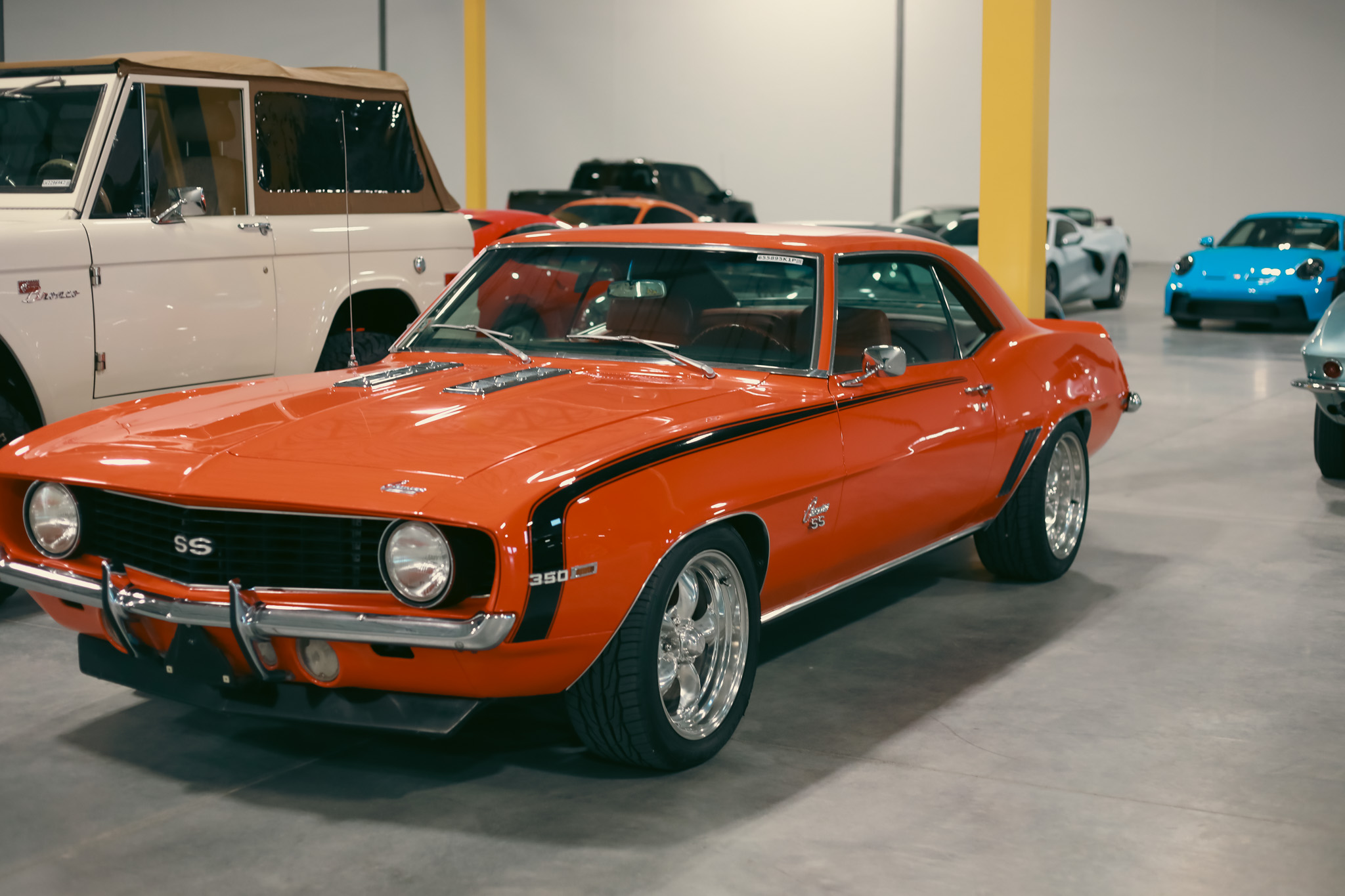 1969 Chevrolet Camaro SS 350 orange with black stripe surrounded by the full GTM collection