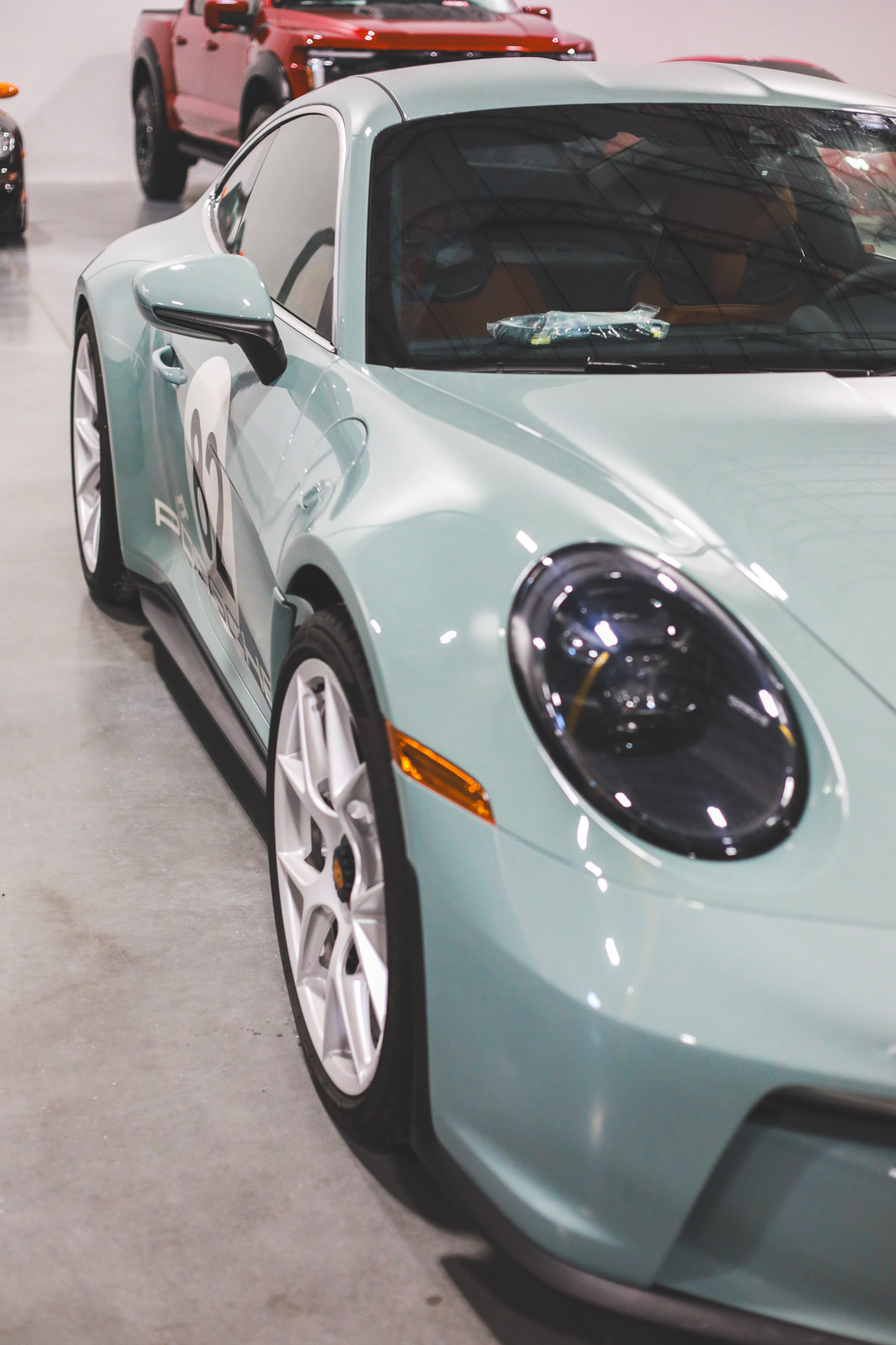 Porsche 992 S/T in Gulf mint with racing number 62 livery, low front-quarter