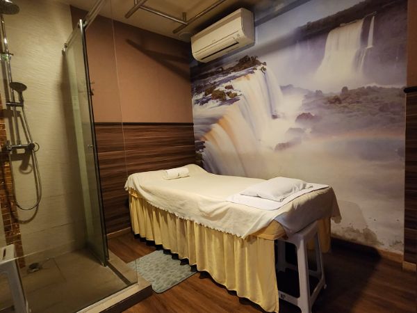 Private massage room with waterfall mural