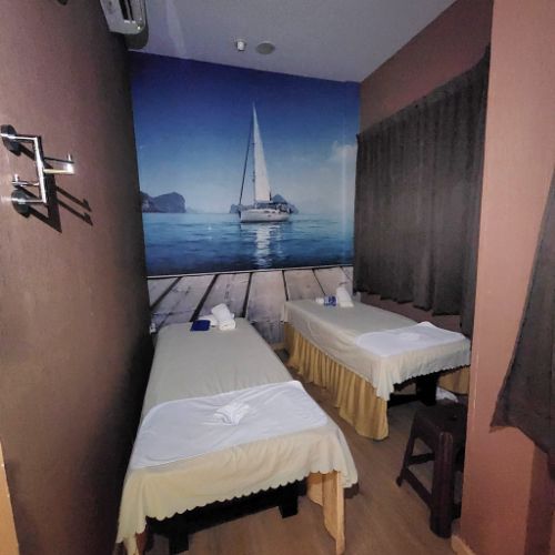 Couples massage room with sailboat mural