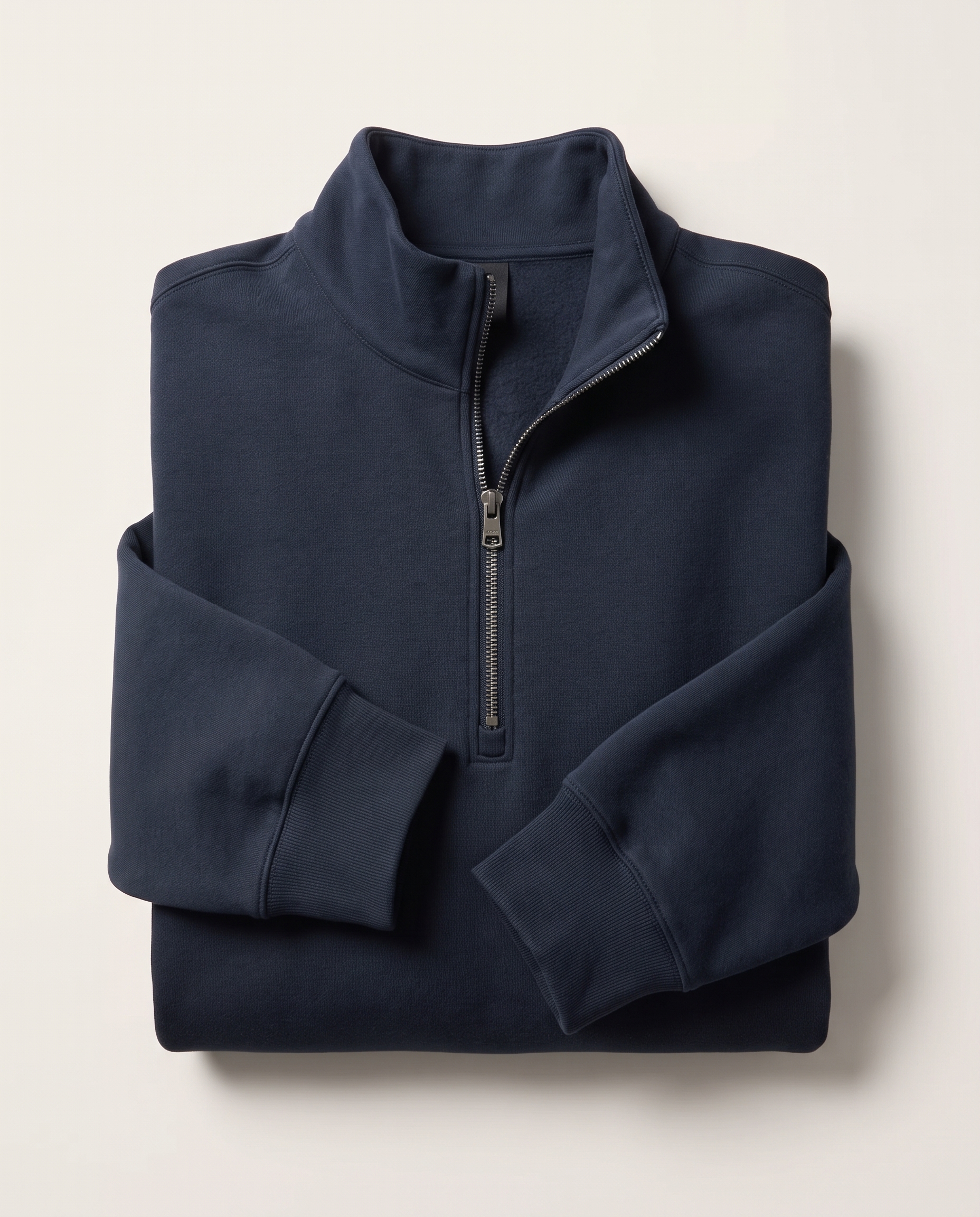Folded navy quarter-zip sweatshirt from a ready-to-ship apparel collection
