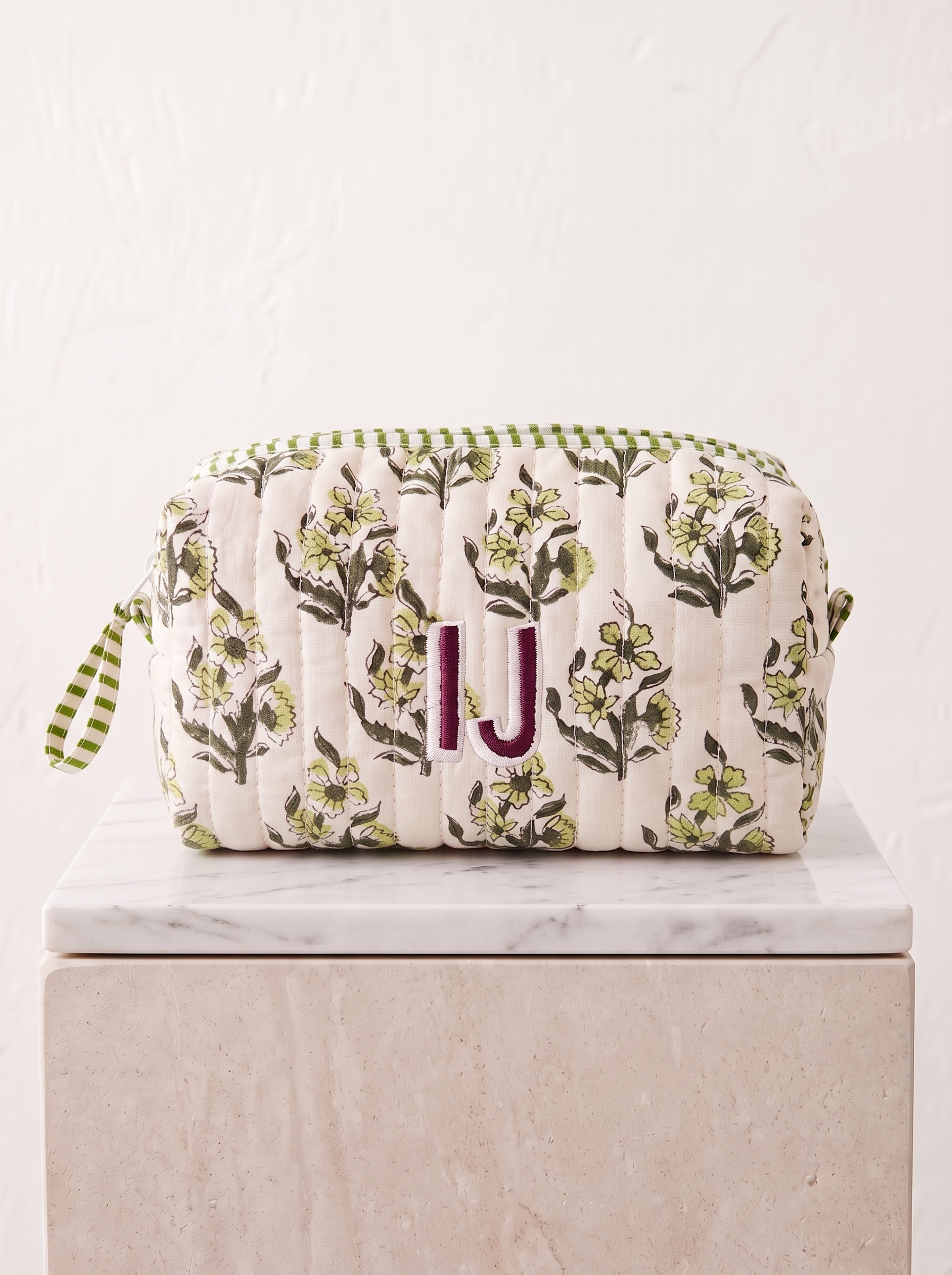 Made from cotton, this floral quilted zip pouch is finished with an embroidered initial.