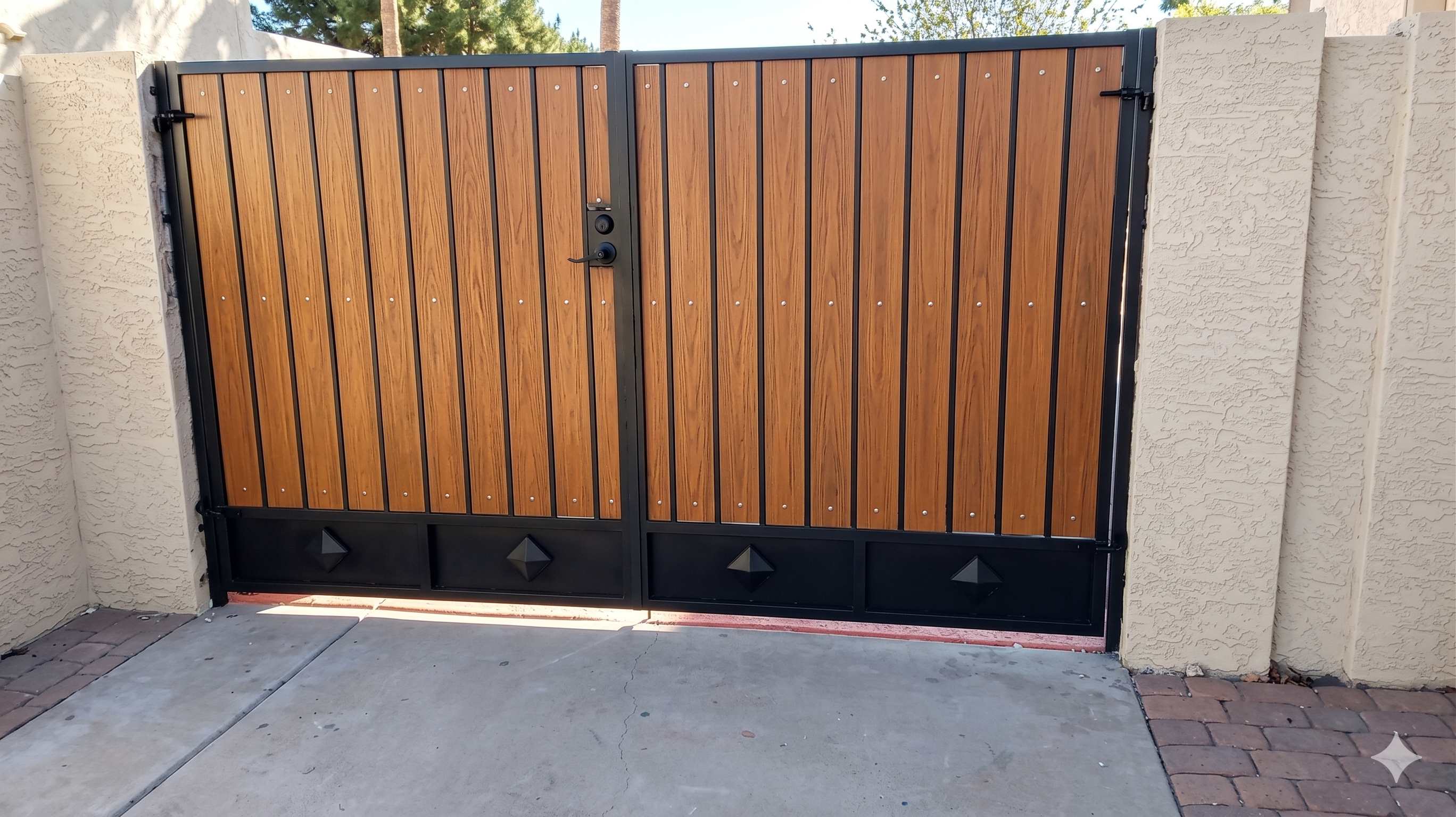 Double RV gate with wood grain panels and diamond accents in black frame