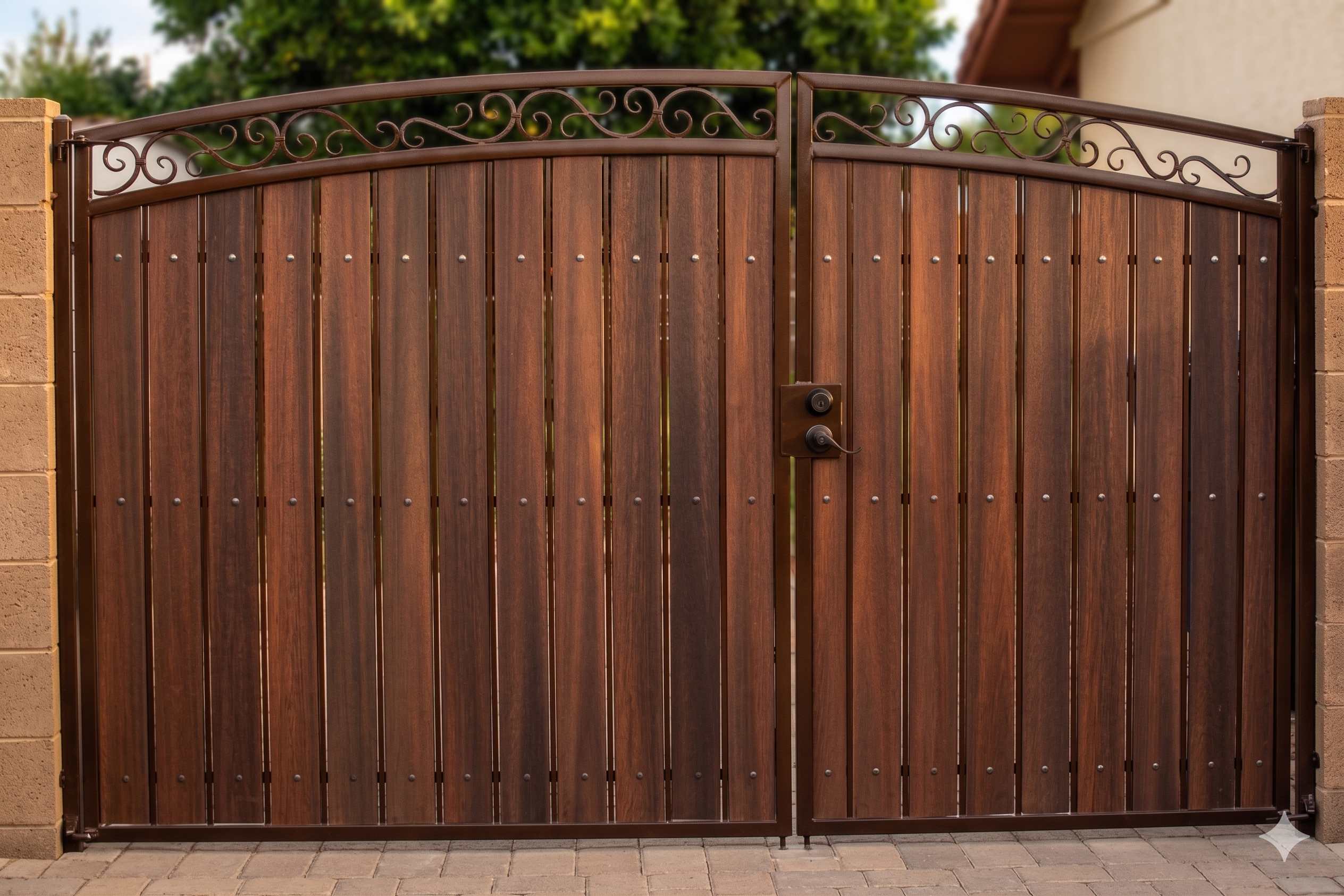 Large ornate double RV gate with scrollwork and dark walnut wood grain
