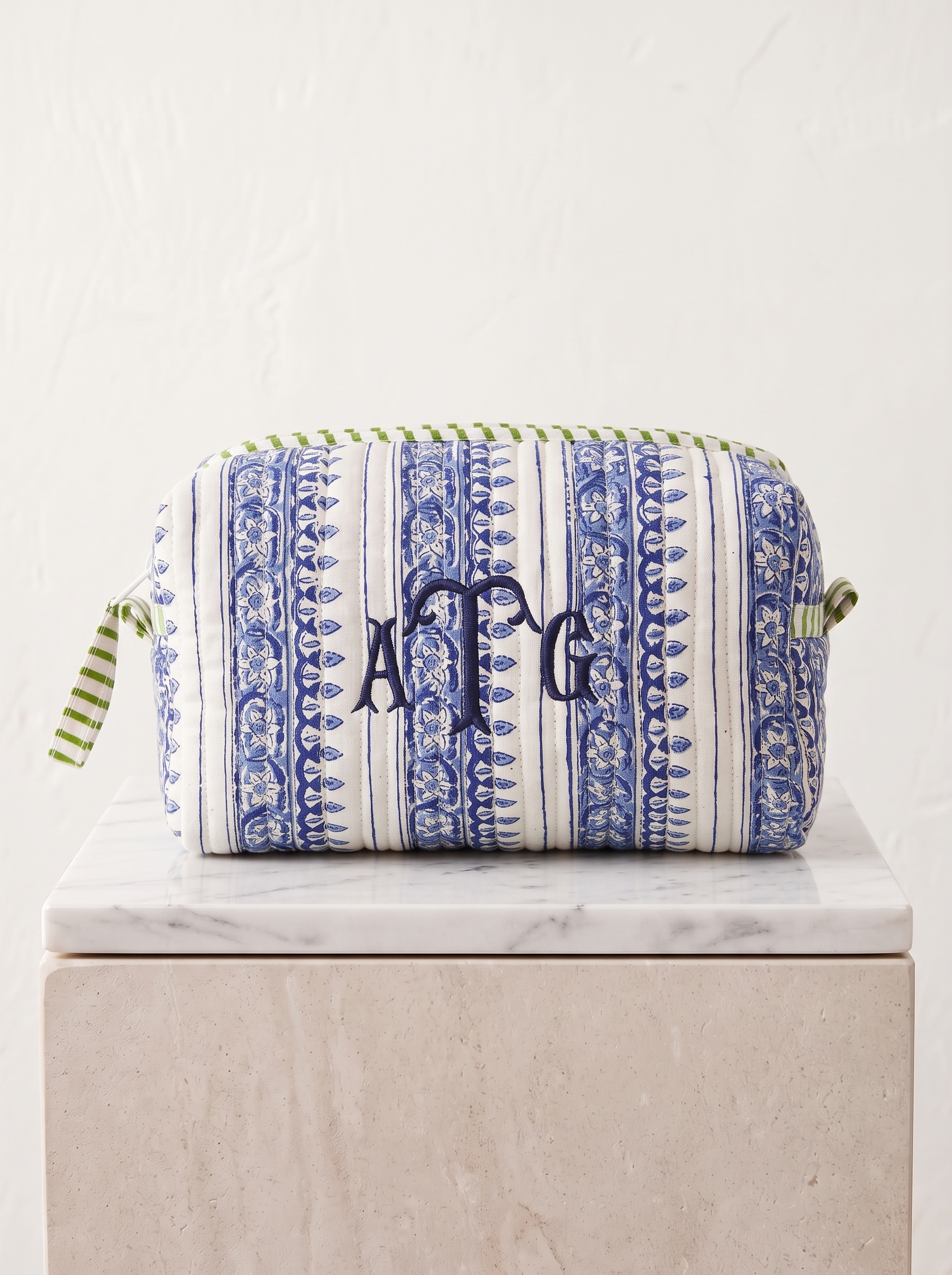 Made from cotton, this quilted zip pouch features a classic blue-and-white block-print stripe.