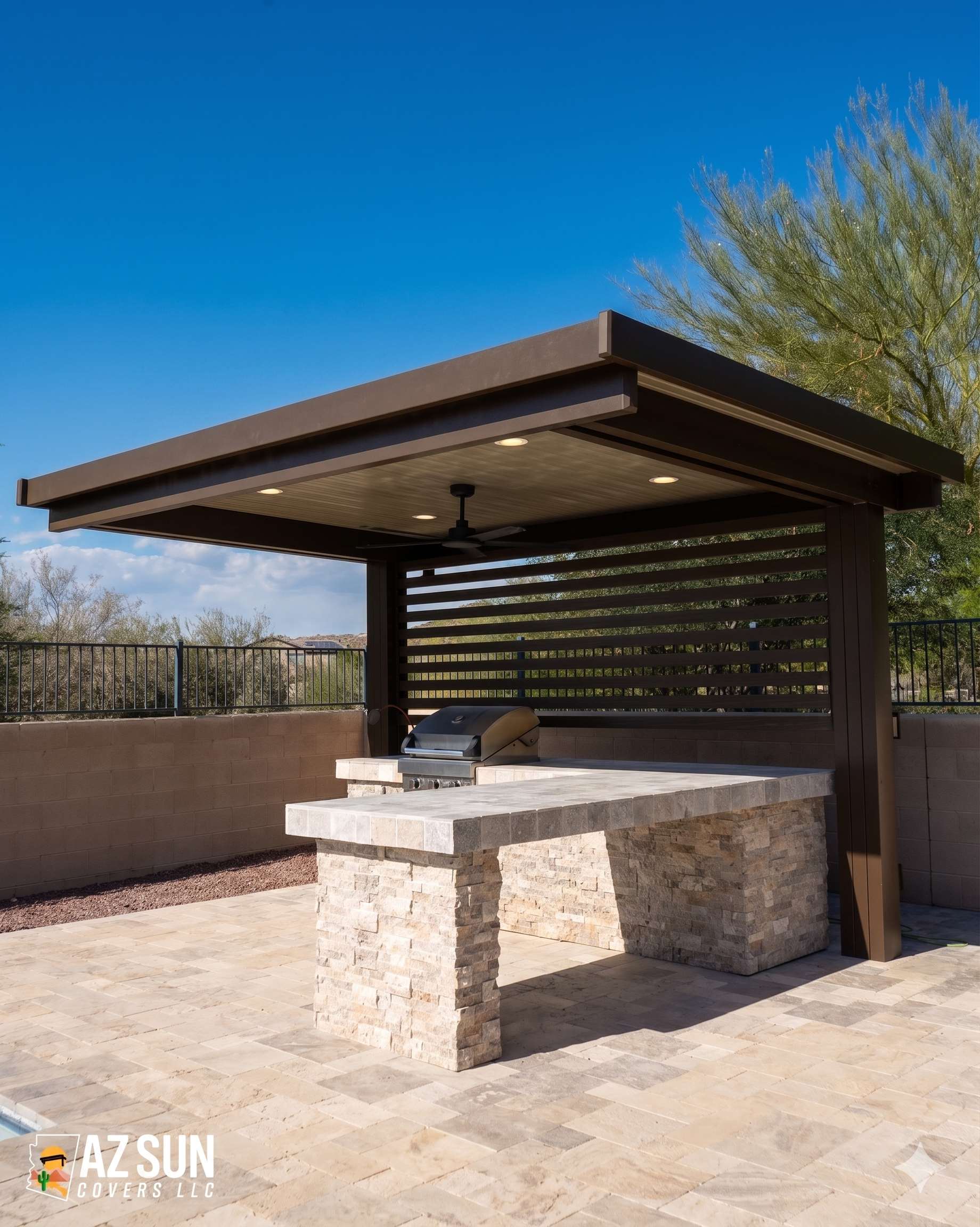 Bronze pergola with ceiling fan over stone outdoor kitchen