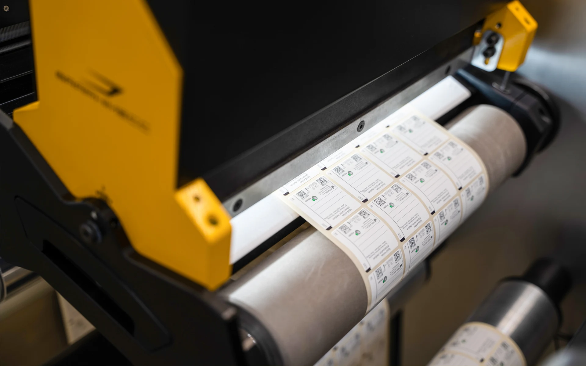 QR code labels on roll passing through Graphimecc machine