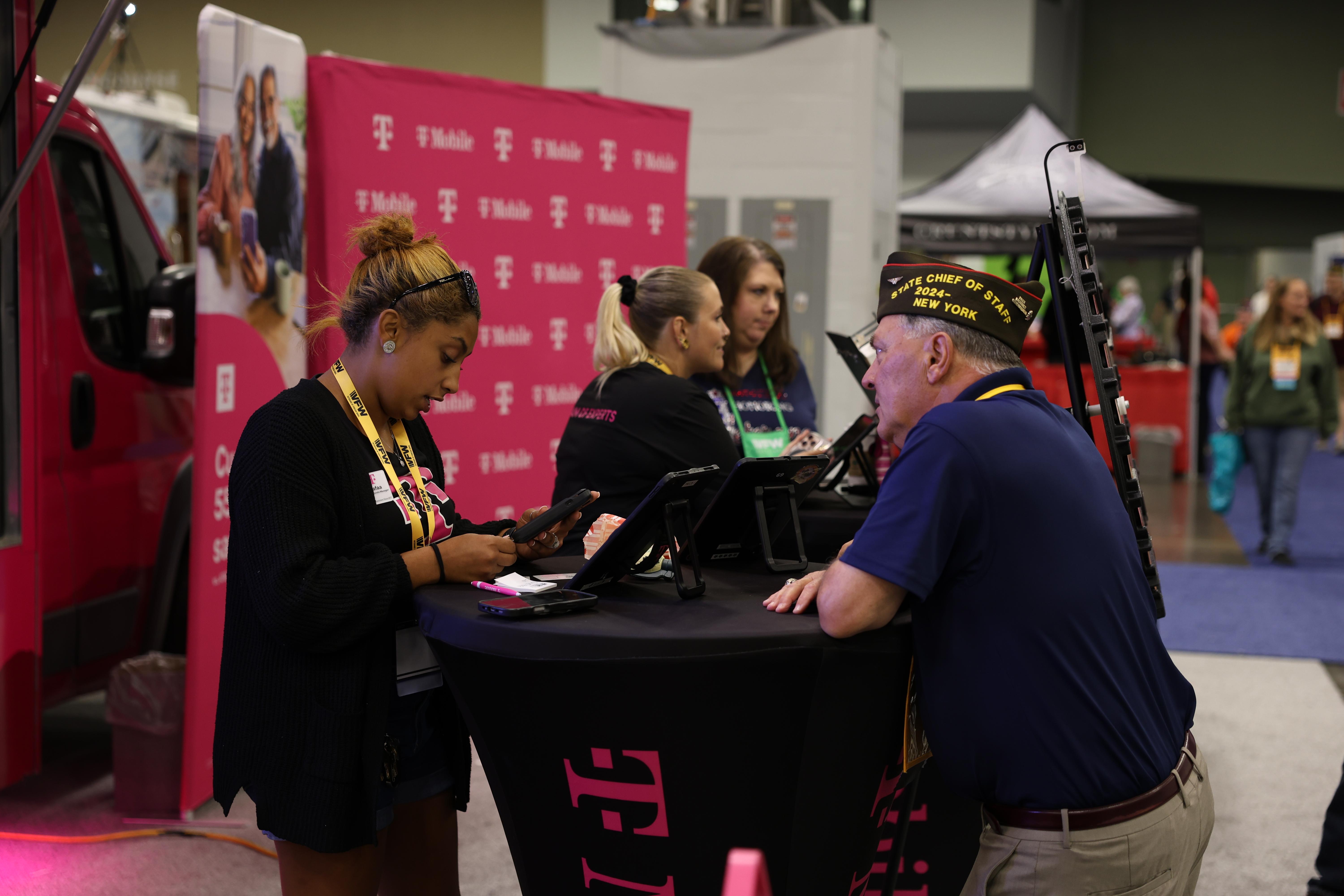 A VFW member being assisted at a corporate sponsor booth on the floor of the VFW National Convention