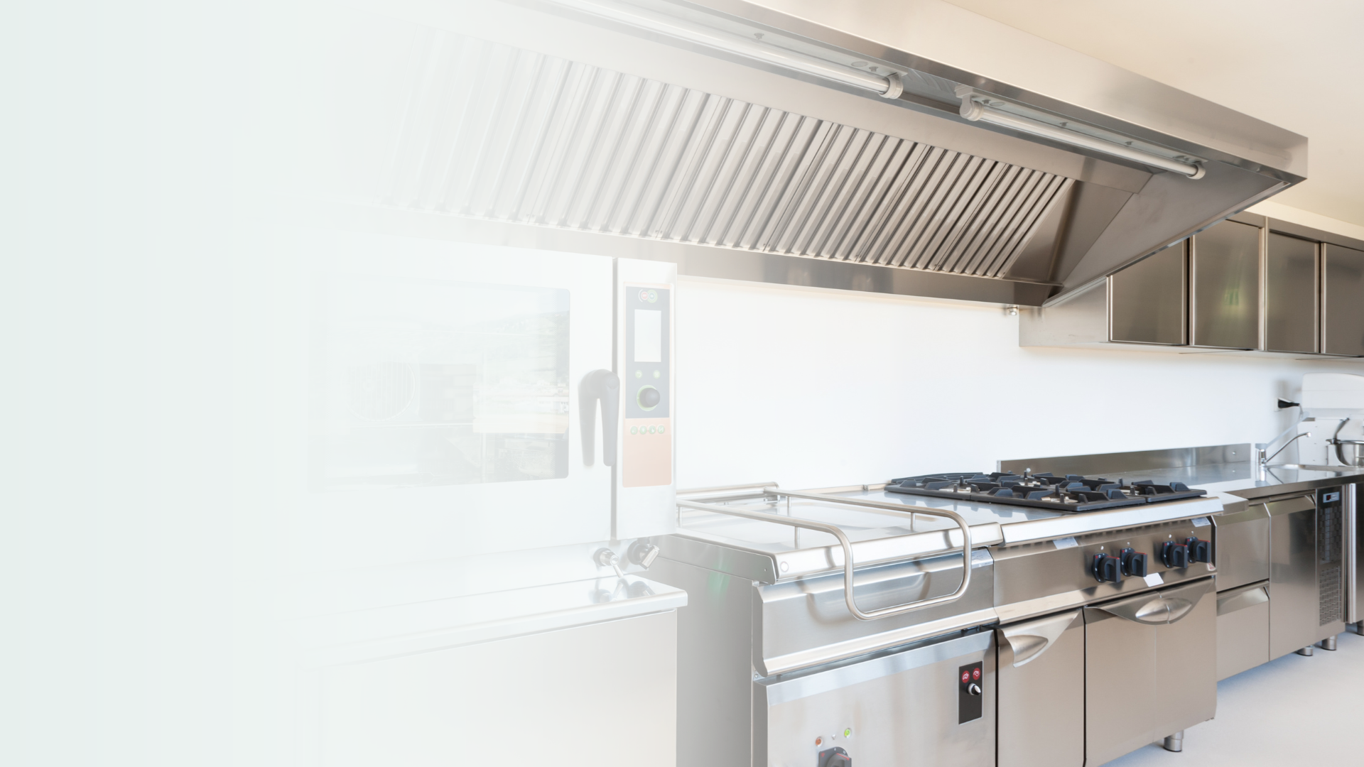Professional commercial kitchen with gas range and hood