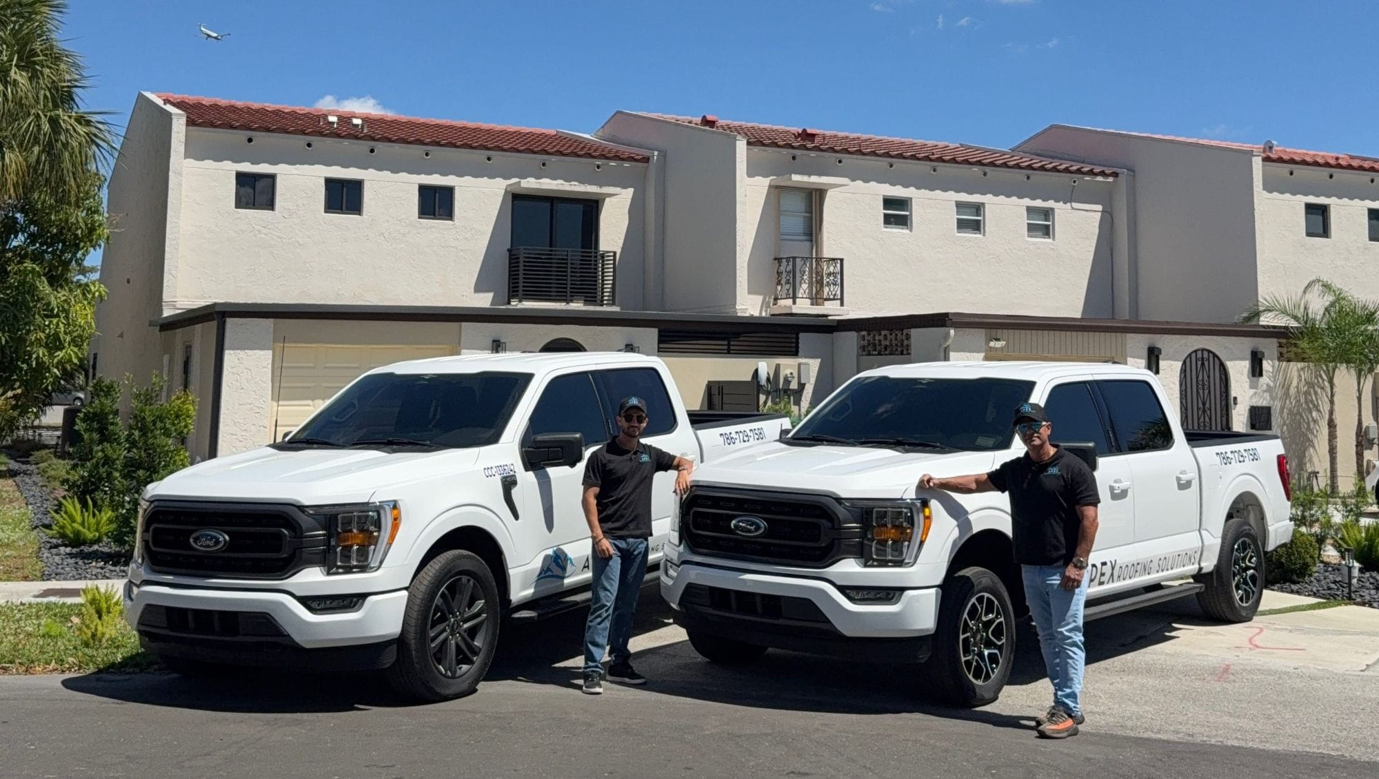 Apex Roofing Solutions team with service vehicles