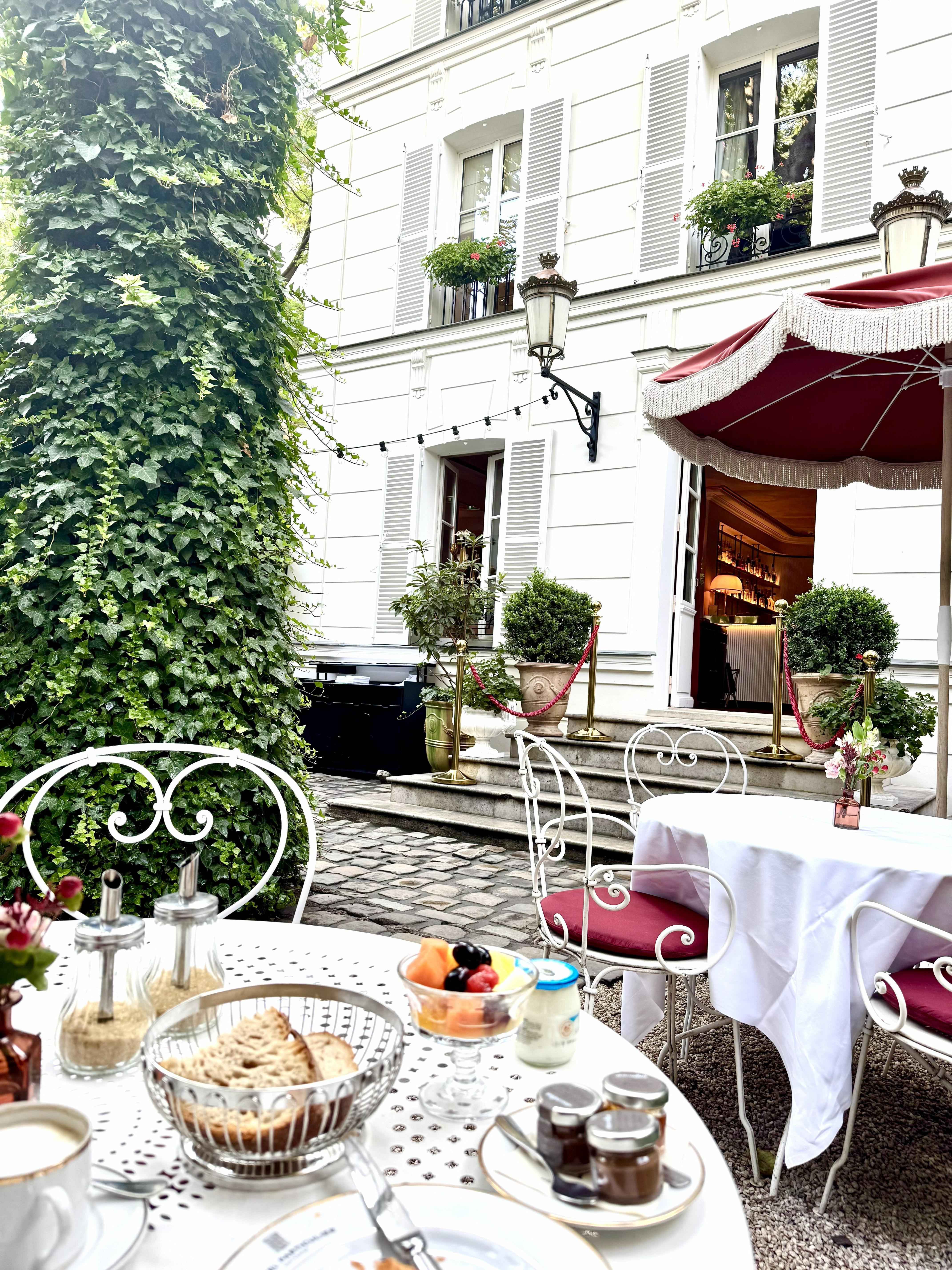 Hidden hotel garden courtyard with breakfast