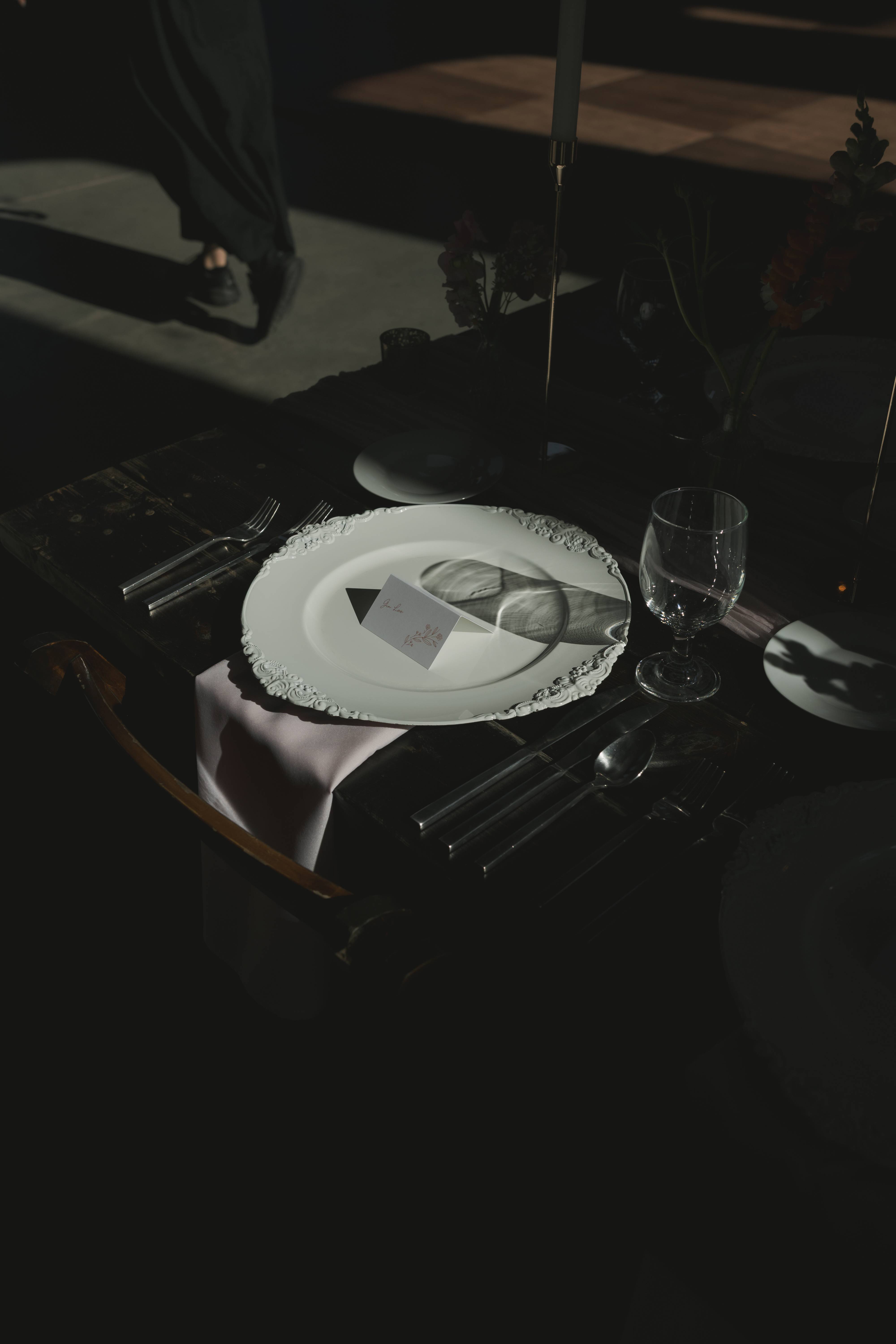 Fine-art reception place setting with ornate charger and candlelight