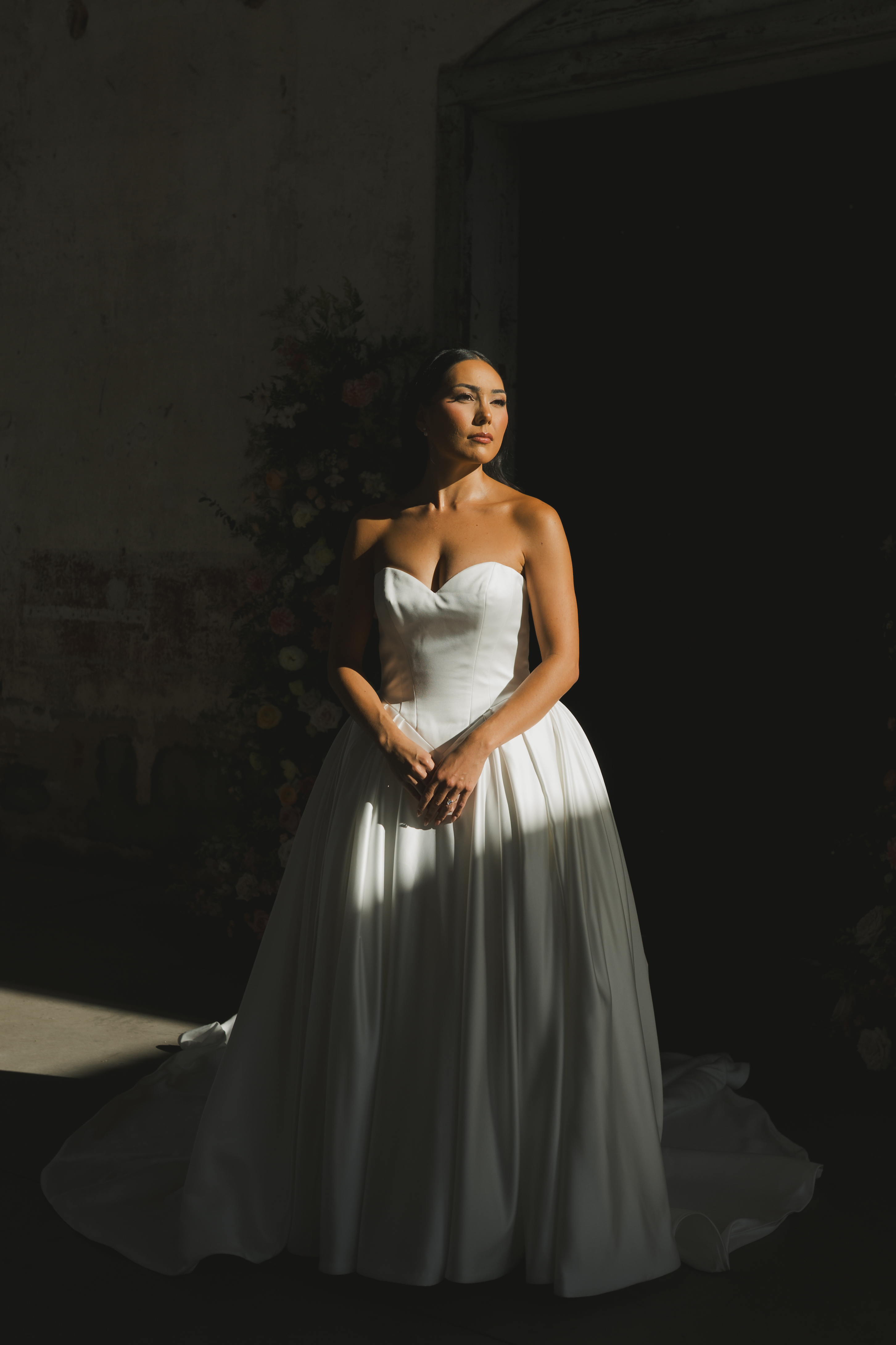 Bride in dramatic natural light at a rustic Texas wedding venue