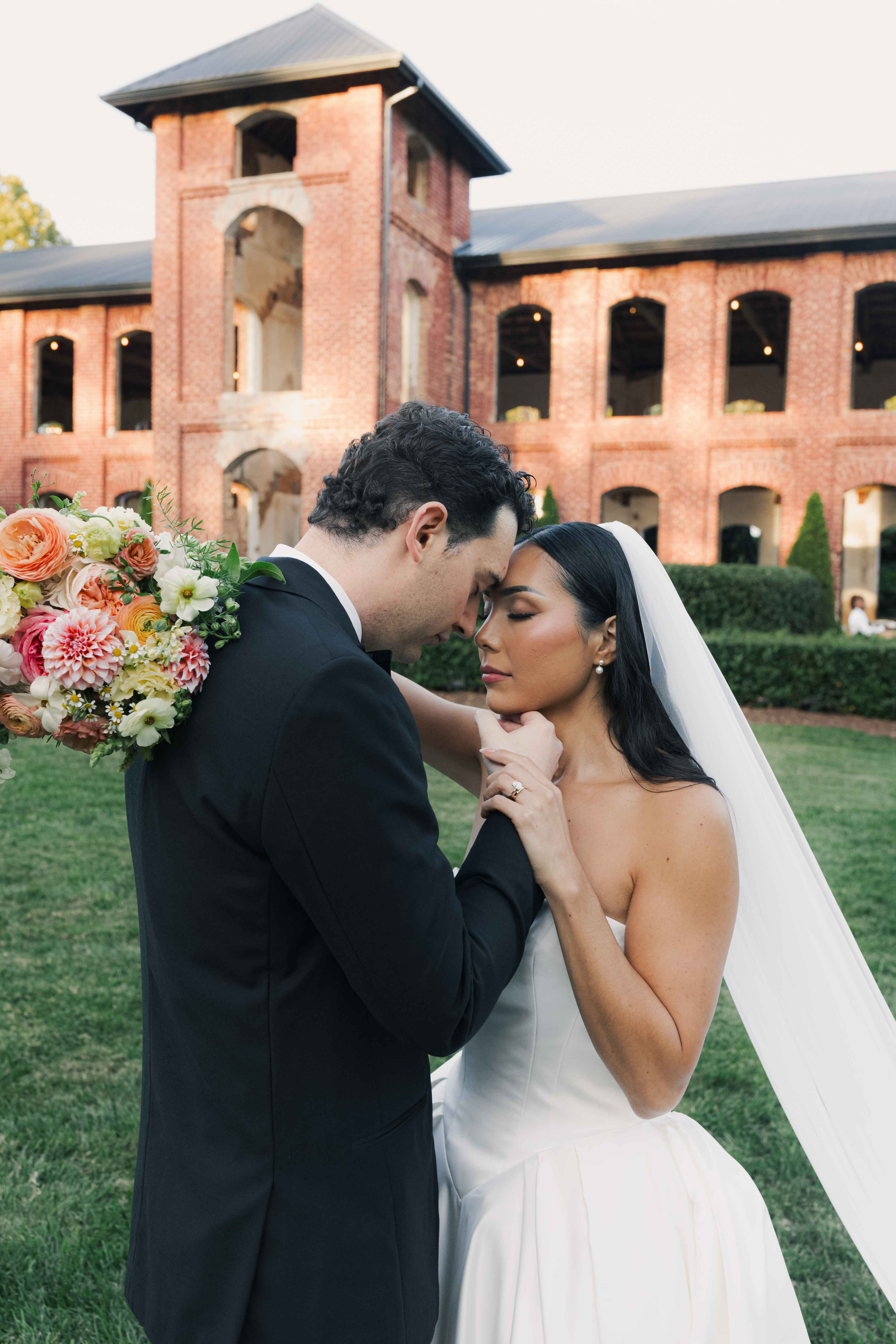 Bride and groom in an intimate forehead-to-forehead moment at golden hour