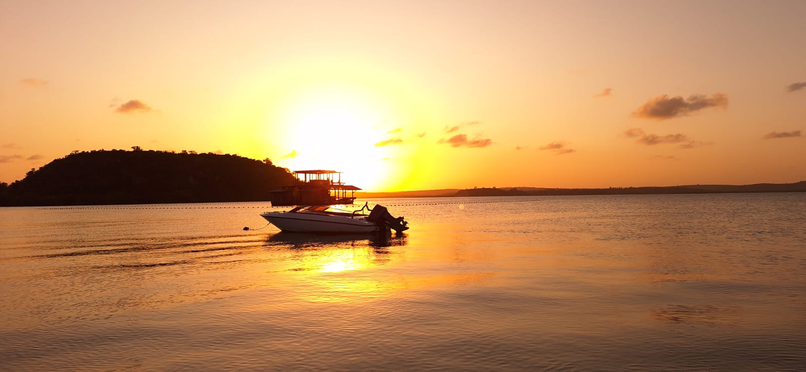 Luxurious sunset over water with a boat