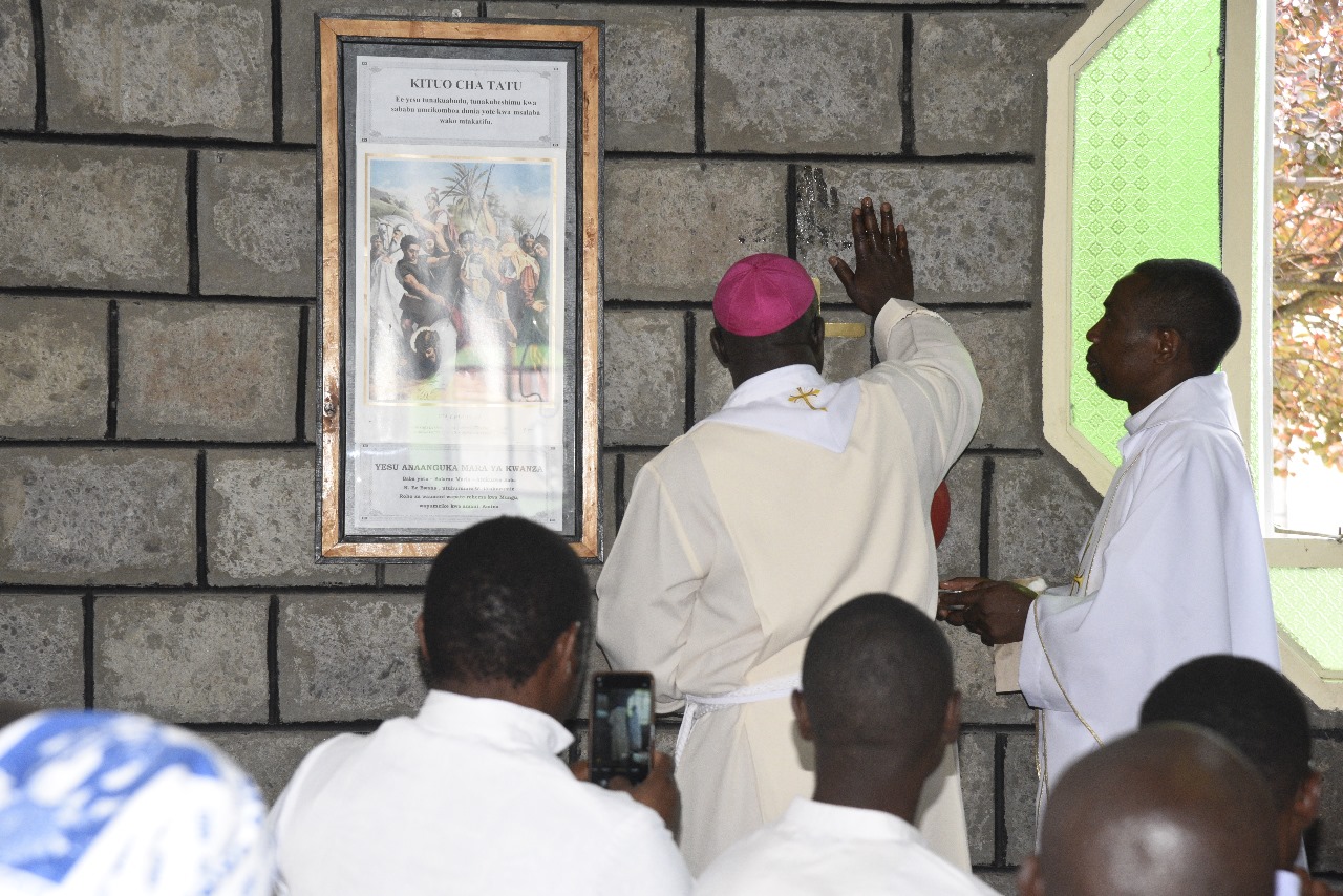 Bishop blessing a Station of the Cross during the church's development phase