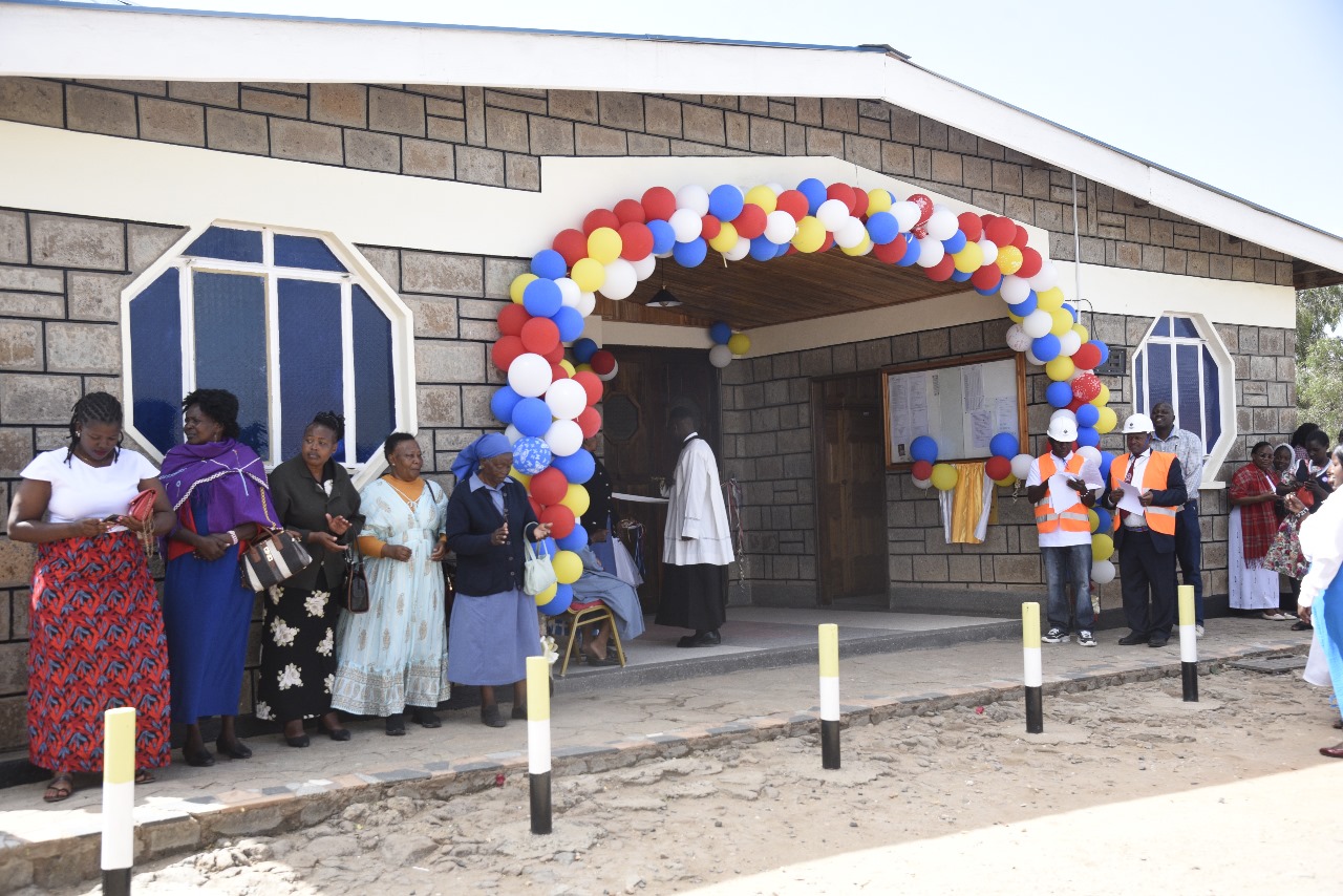 Church entrance decorated with balloons as parishioners gather