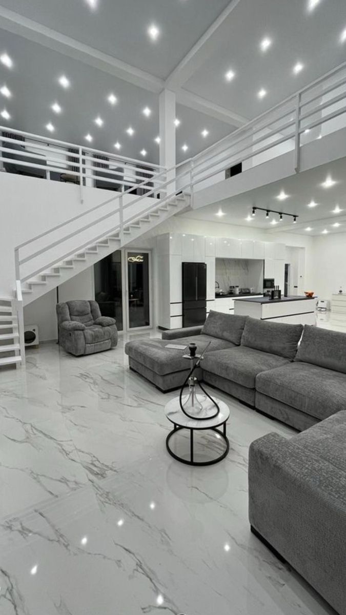 Modern white open concept living room with marble floors