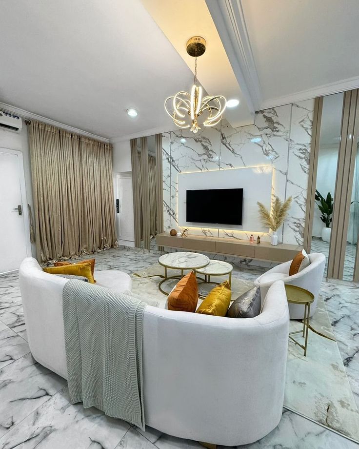 Luxury living room with marble floors and white curved sofa