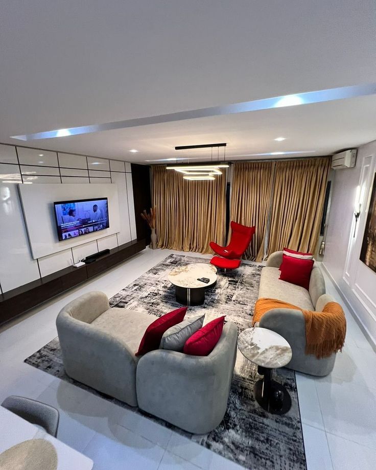 Contemporary living room with gray furniture and red accents