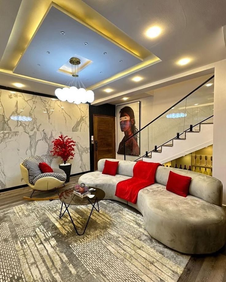 Living room with red accents, marble wall and glass staircase
