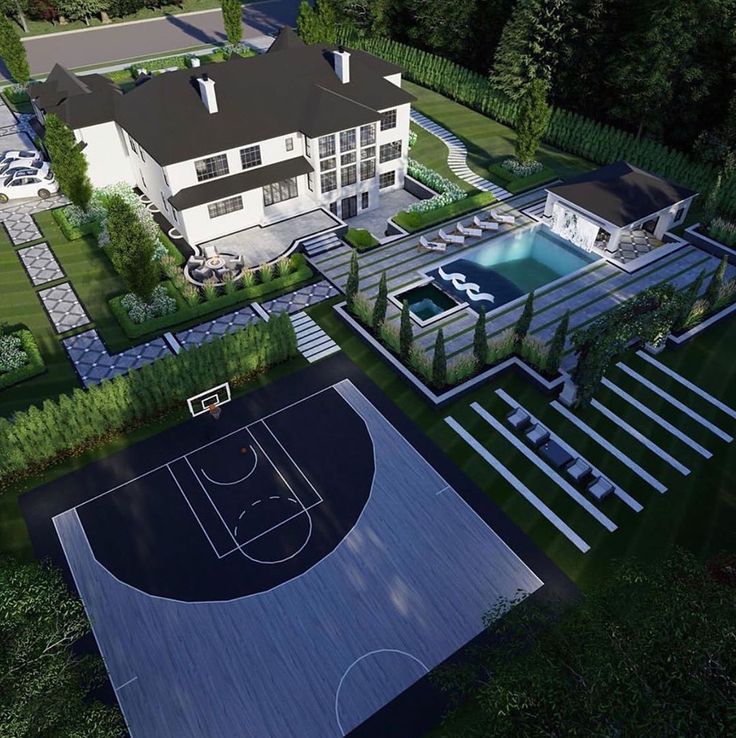 Aerial view of a large house with pool, basketball court, and landscaped garden