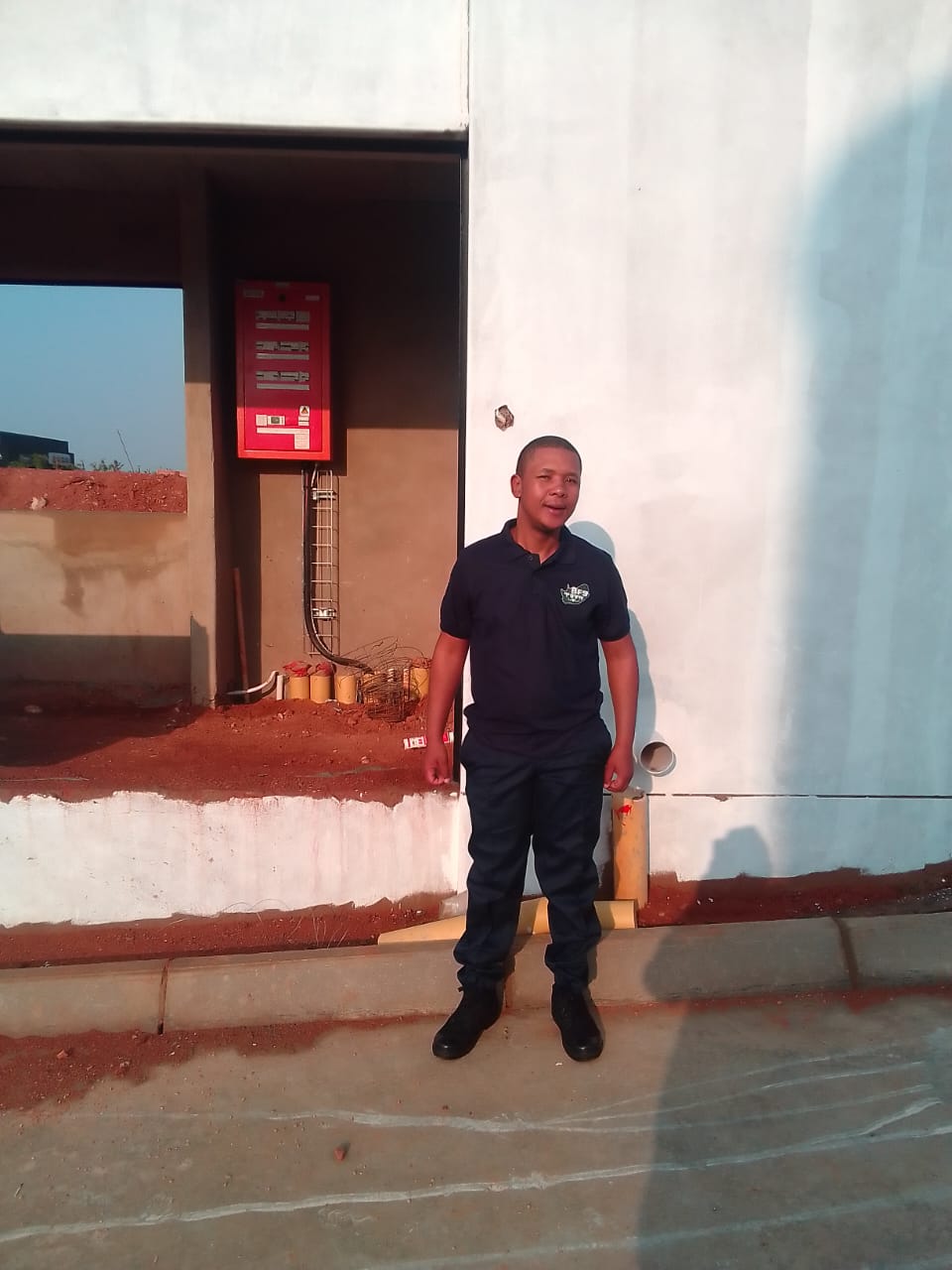 BFS security guard at construction site with fire alarm panel