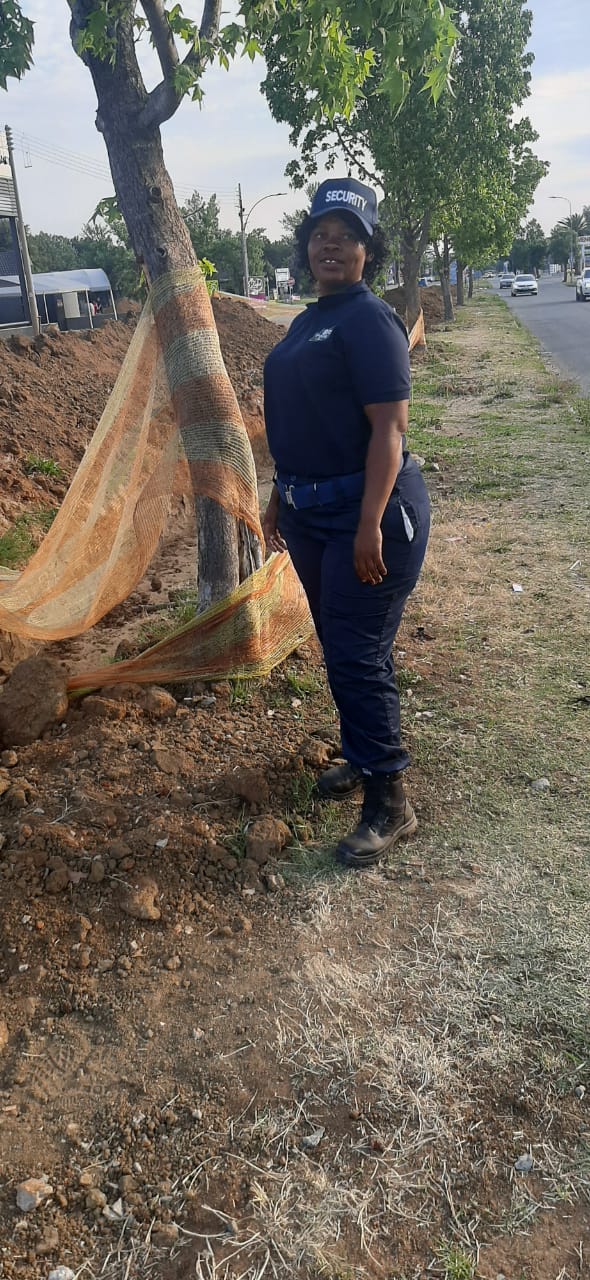 Female BFS security officer at construction site with safety netting