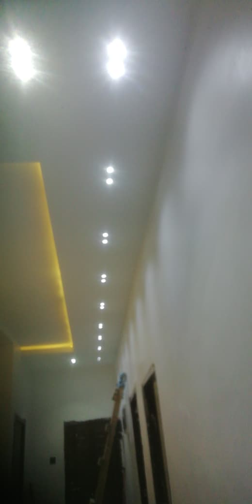 LED ceiling downlights and warm cove lighting - corridor view