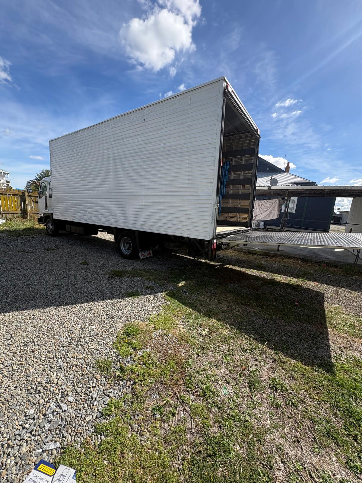 Moving truck with rear door open showing ramp