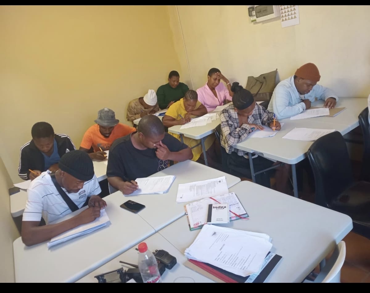 Security trainees studying course materials in classroom