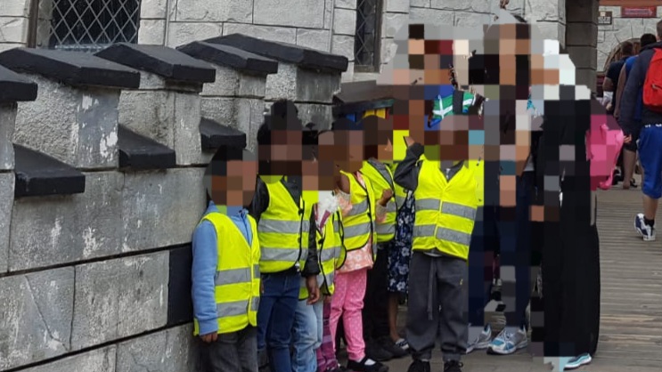 Children visiting stone building attraction