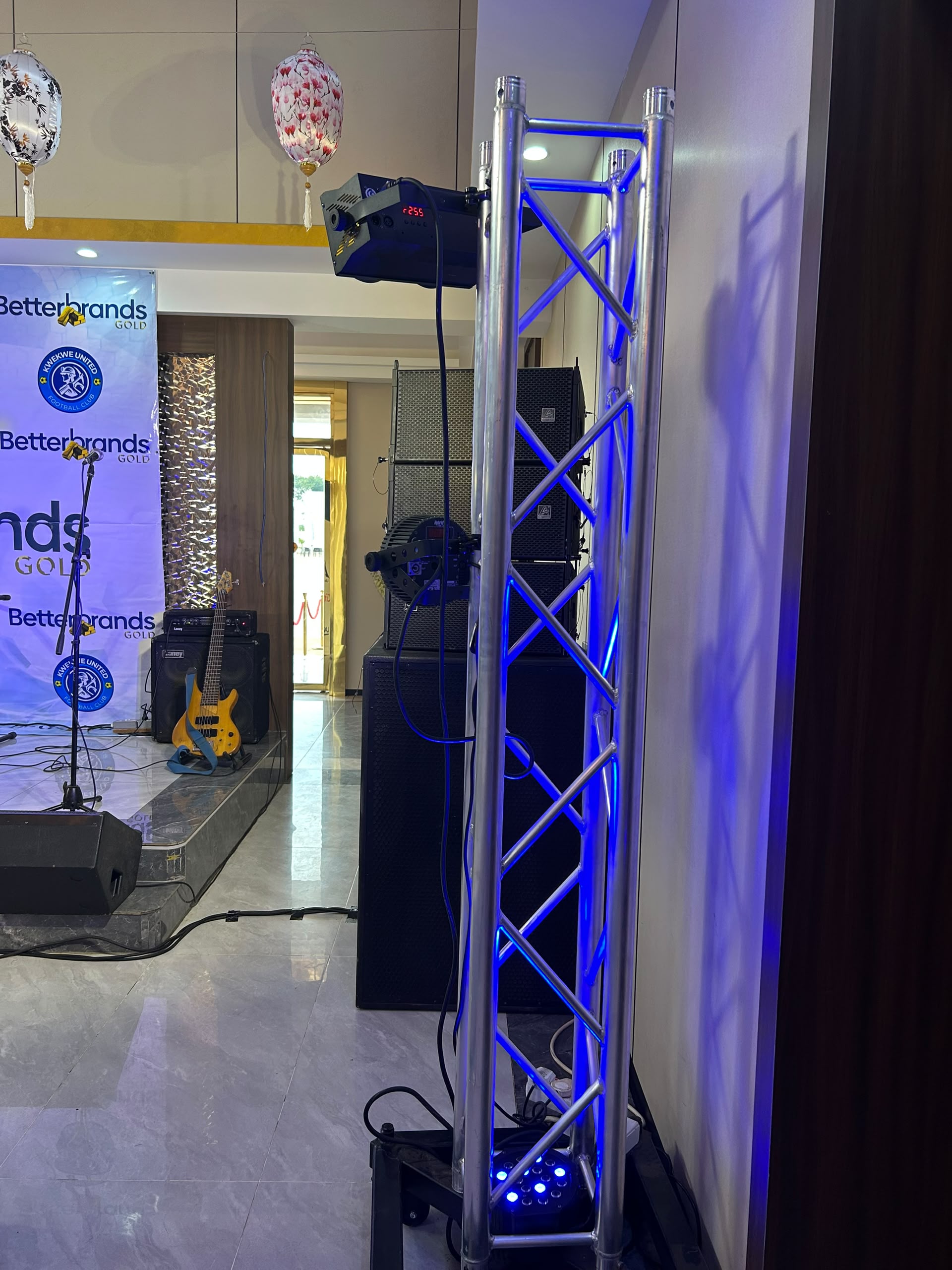 Professional event production with blue LED truss structure and bass guitar stage
