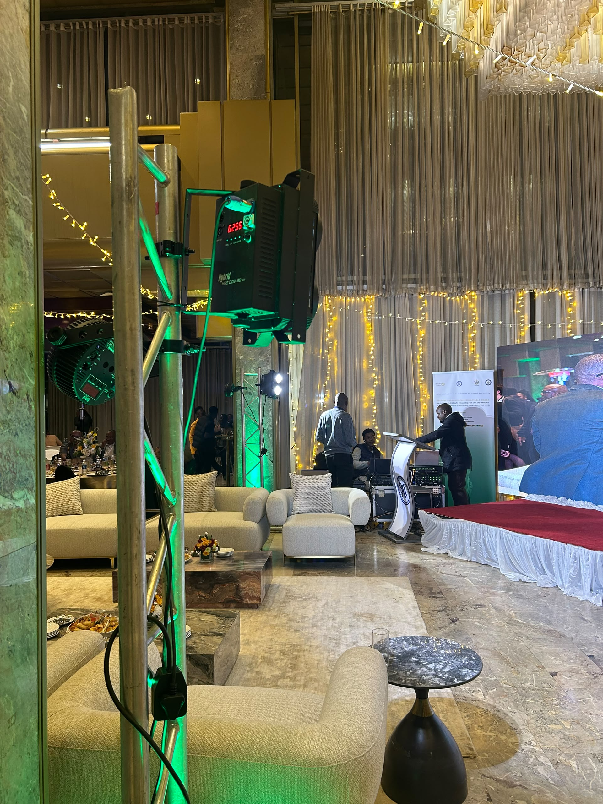 Premium event venue with green accent lighting and sophisticated AV production