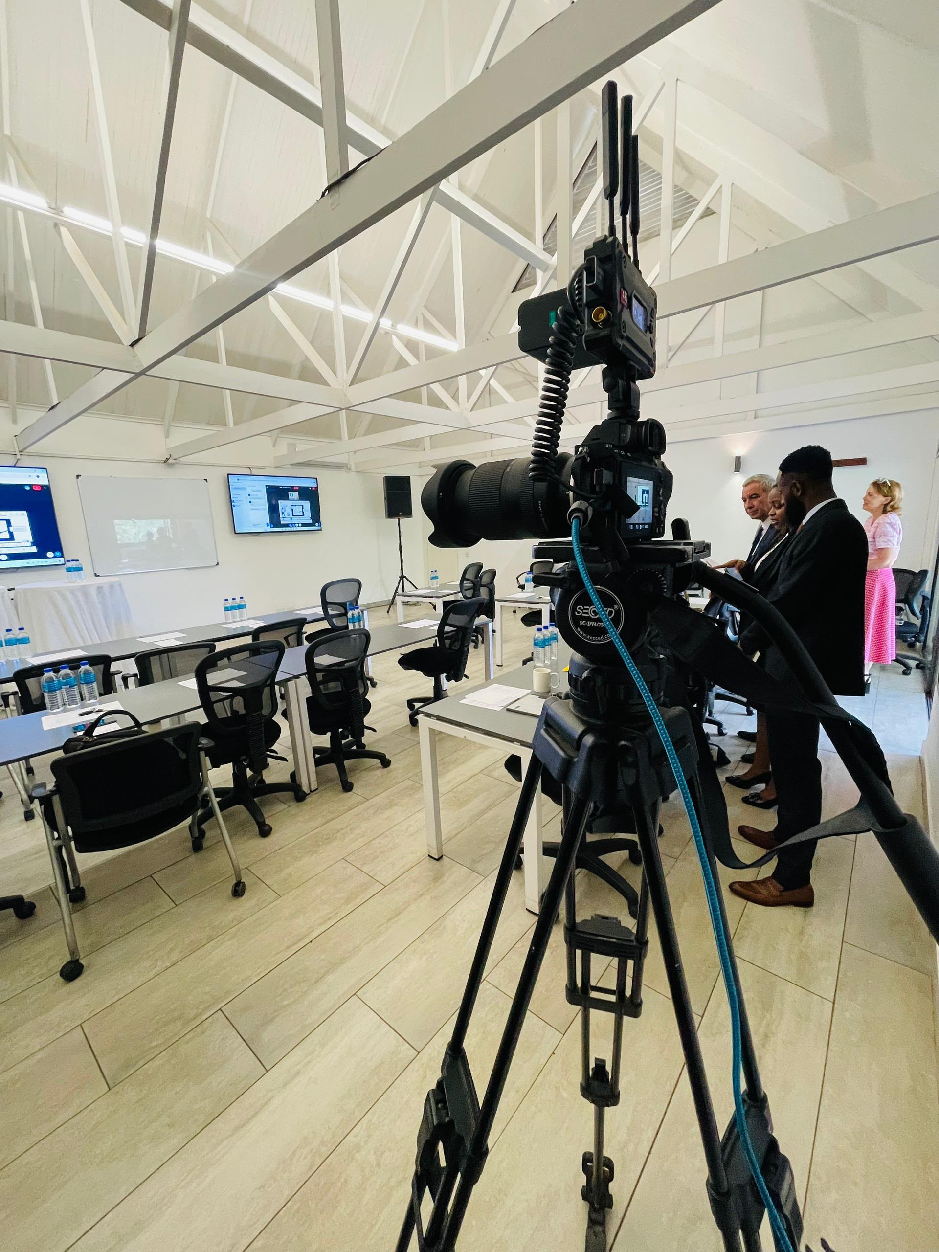 Professional video production in conference room with video camera rig and wireless systems