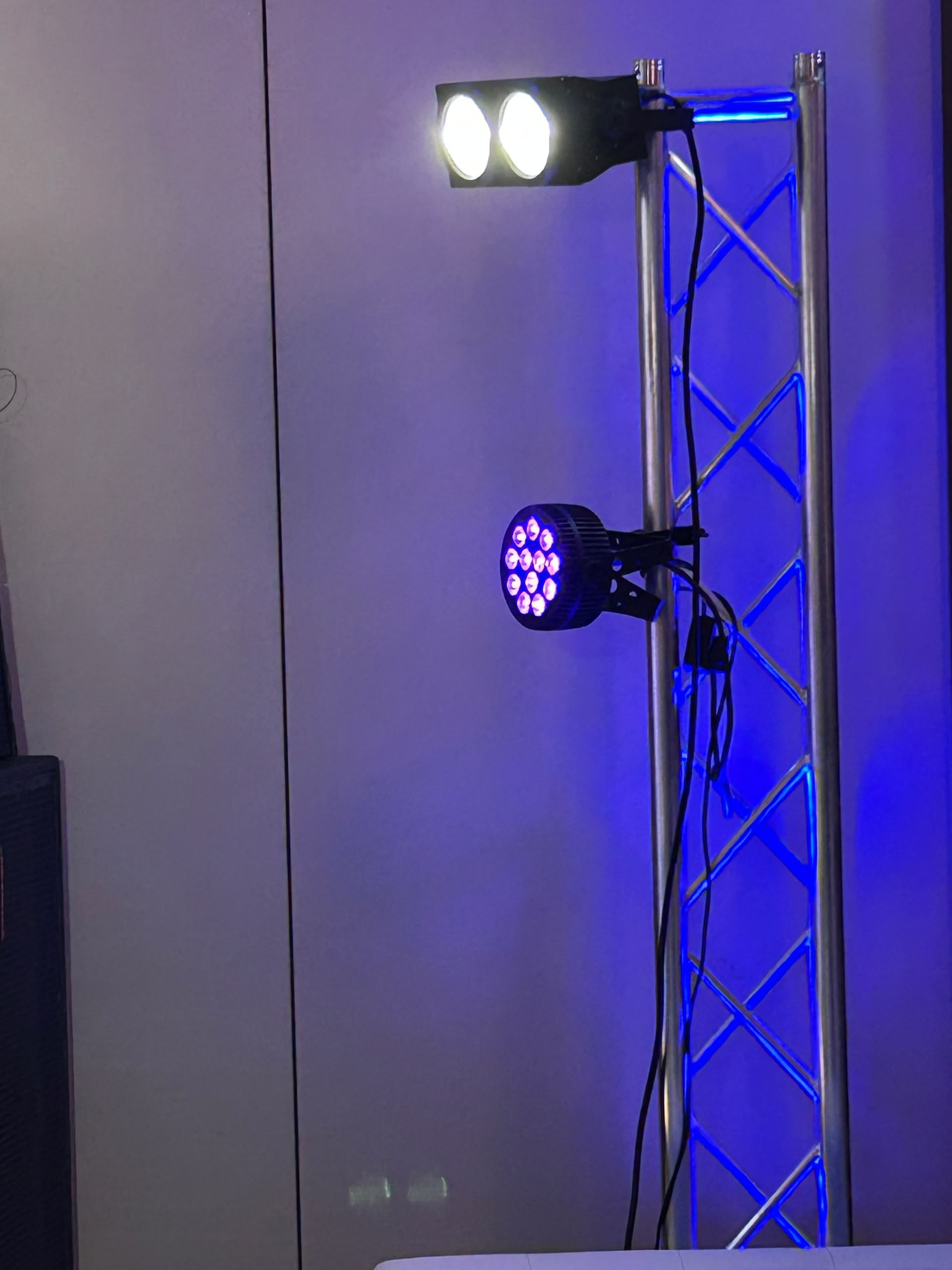 Professional stage lighting with white and magenta LED spots on metal truss
