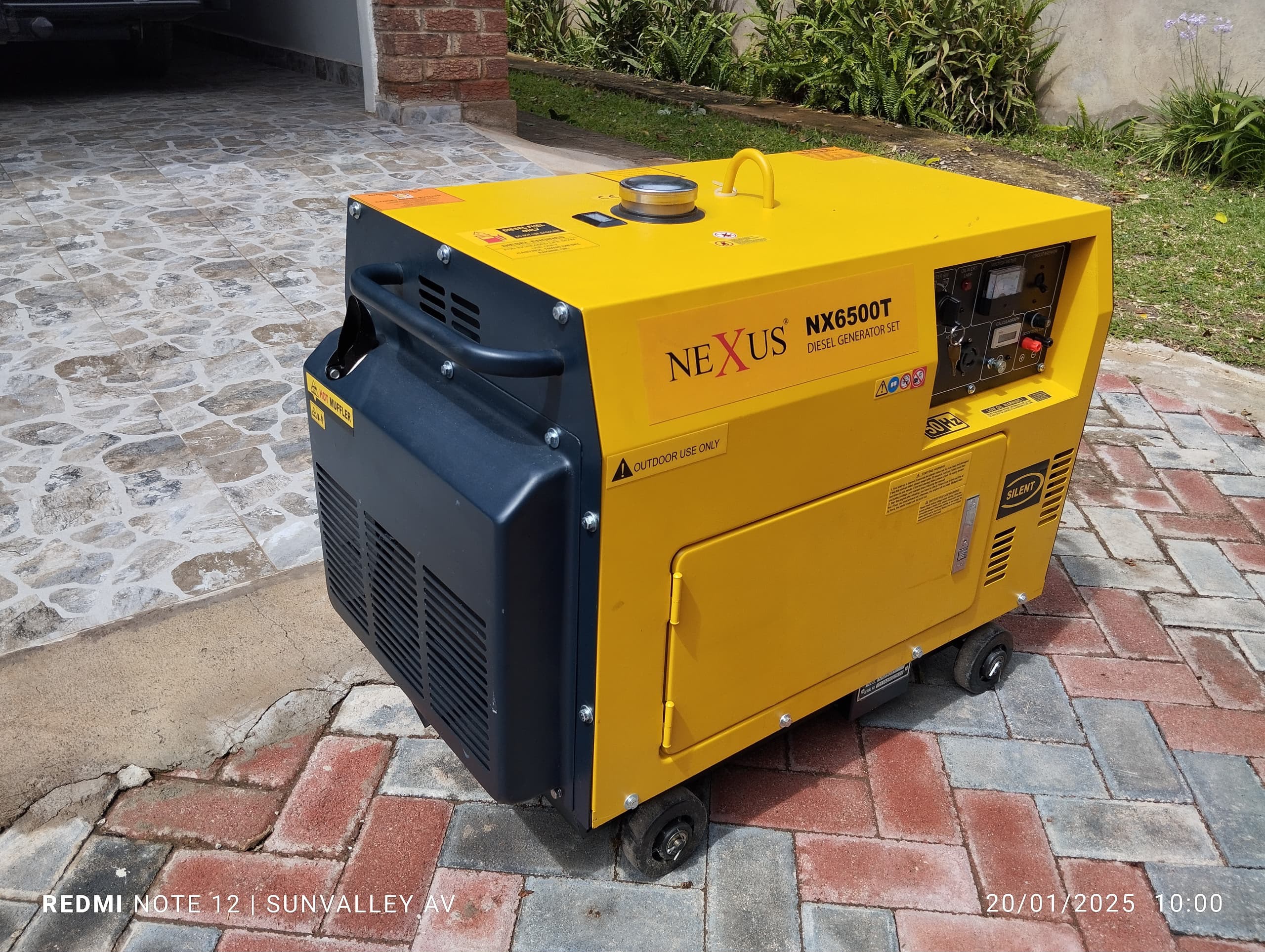 Yellow Nexus diesel generator on residential patio for outdoor event power