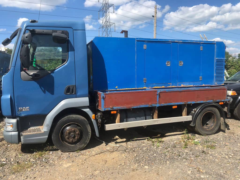 Professional blue transport truck with audio equipment enclosure for event logistics