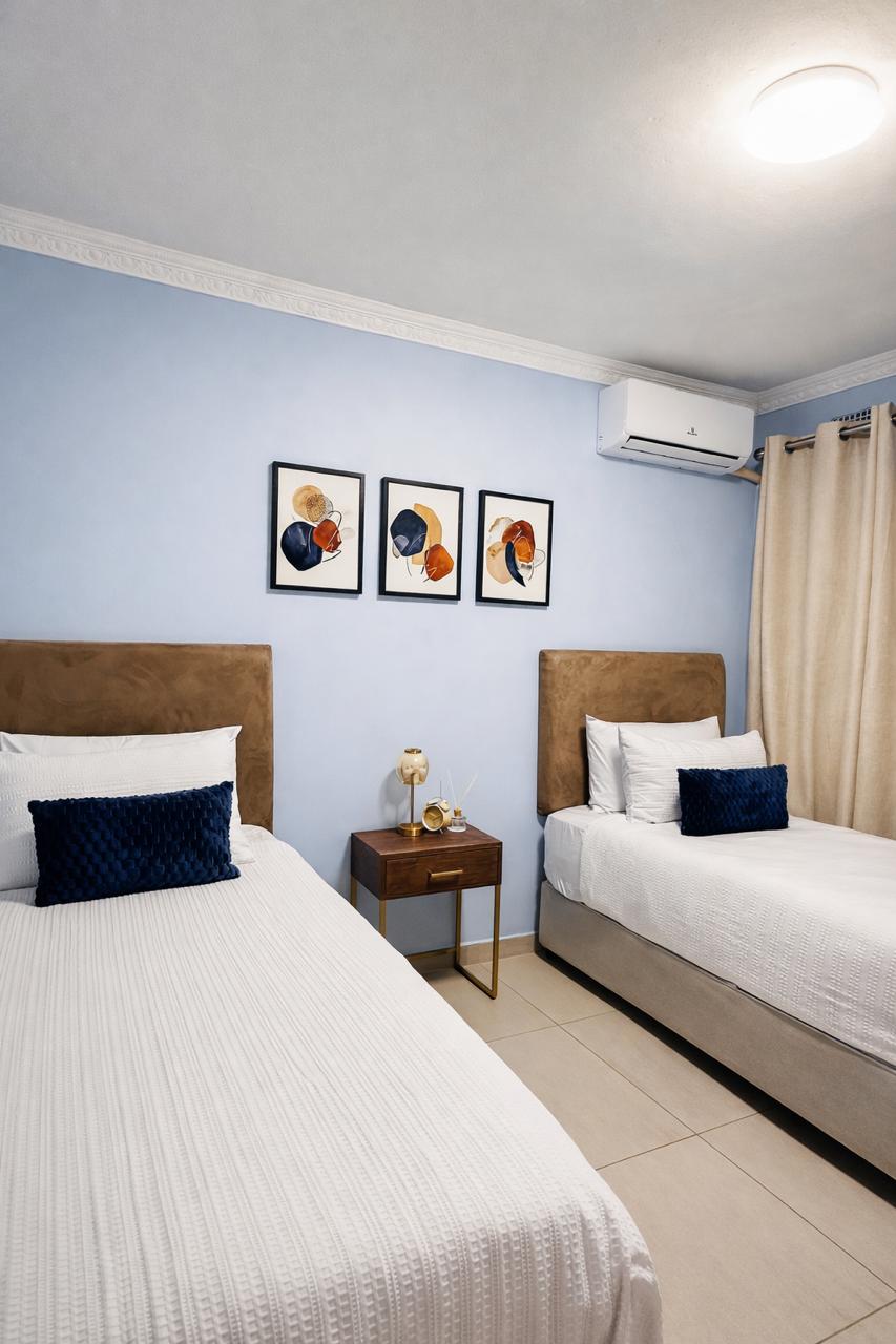 Twin bedroom with two single beds and wooden headboards