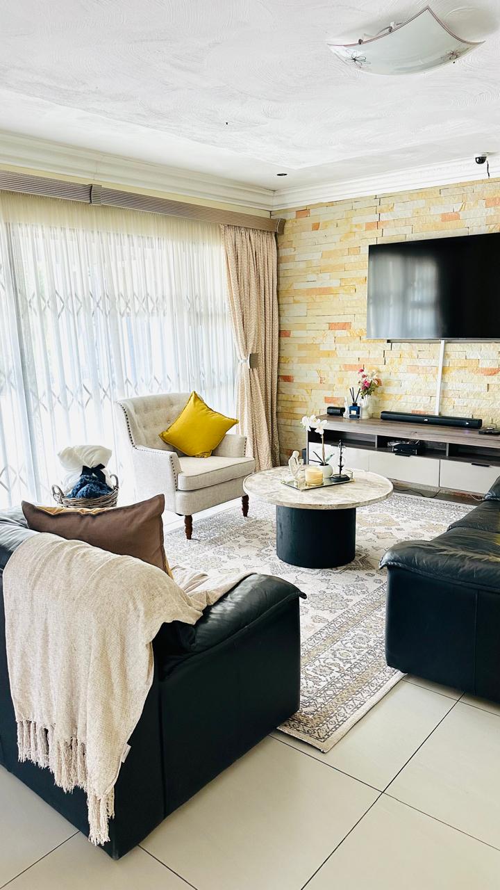 Bright sitting area with armchair and sheer curtains
