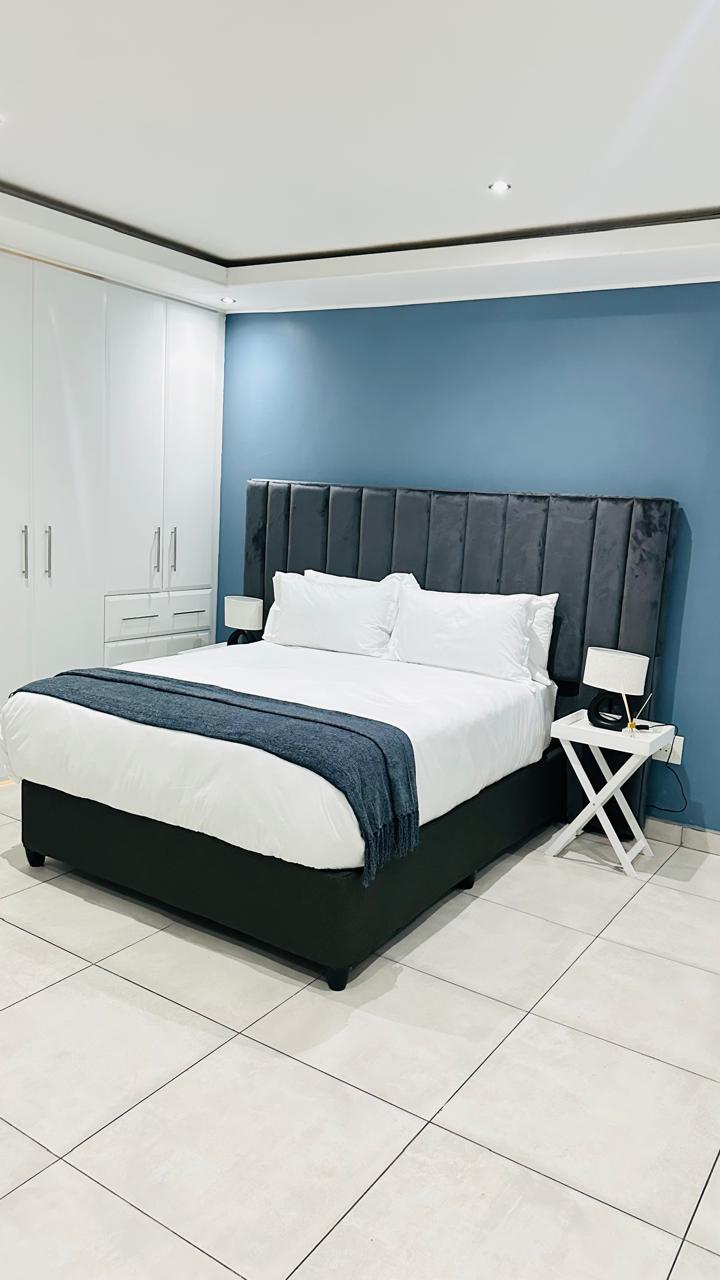 King bedroom with built-in wardrobes and plush bedding