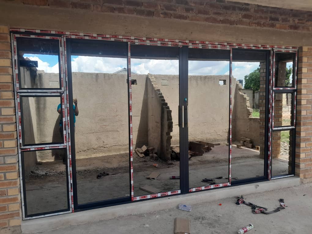 Aluminium and glass — wide bi-fold glass door installation in brick wall